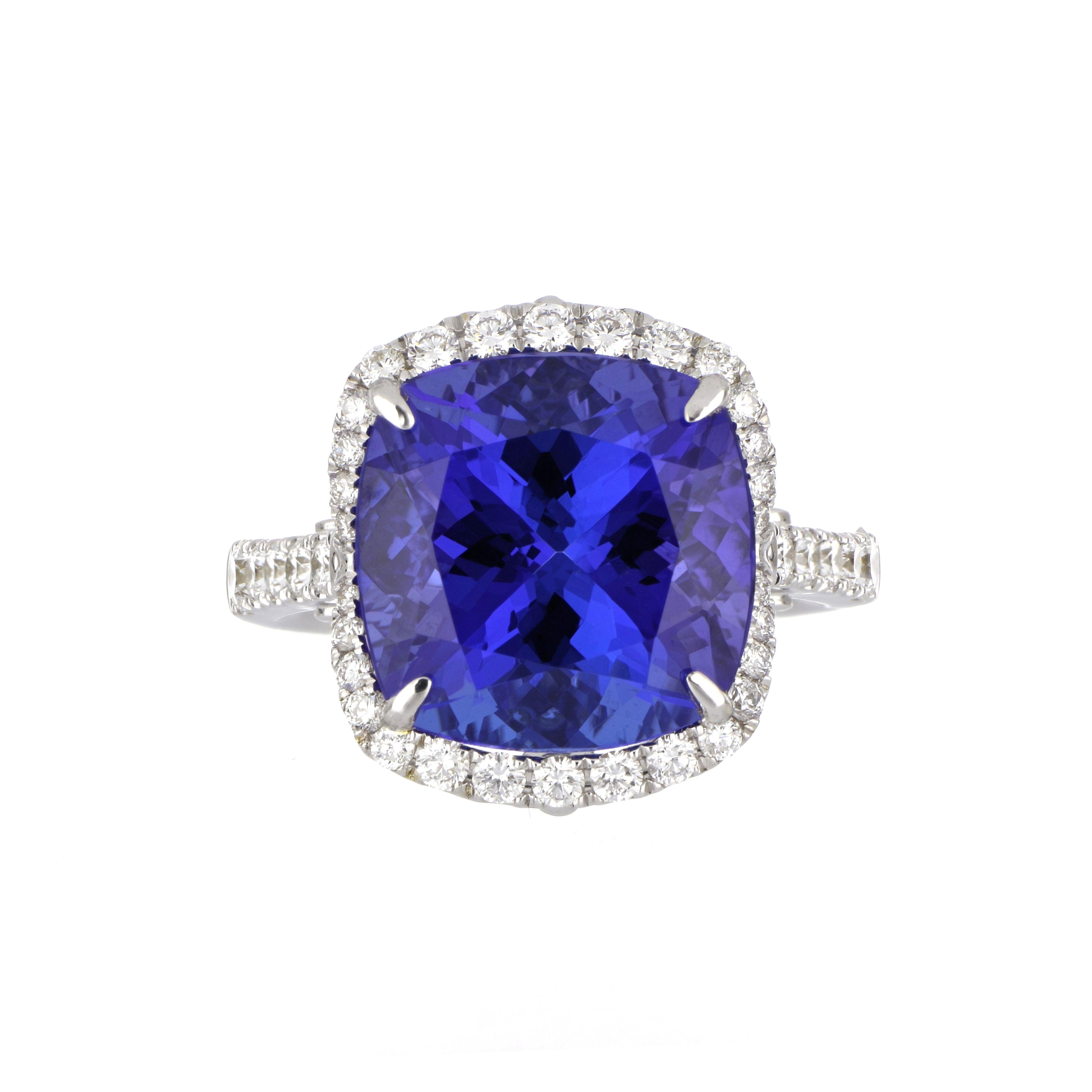 Elegant and exquisitely detailed 18K Ring, centre set with 10.80 Ct Tanzanite, surrounded by and enhanced on shank with micro pave Diamonds, weighing approx. 1.02 total carat weight. Beautifully Hand crafted in 18 Karat white Gold.

Stone Size: 13.1