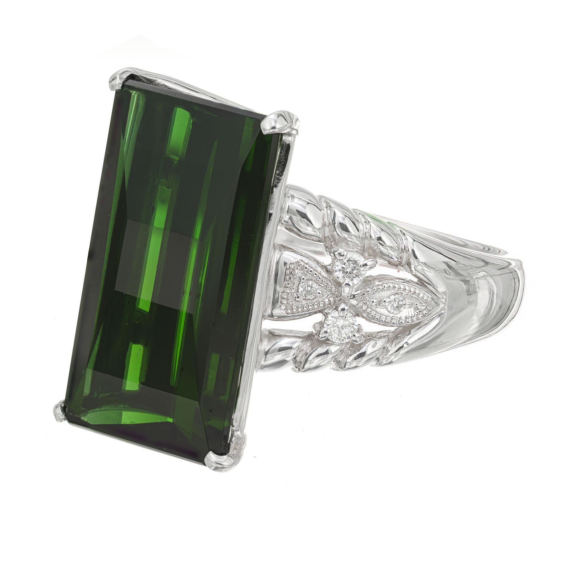 Tourmaline and diamond cocktail ring. Natural green rectangular 10.85 carat custom cut tourmaline in a solid platinum custom made setting with 8 round cut accent diamonds.  

1 rectangular custom cut green tourmaline, VS approx. 10.85cts
8 round