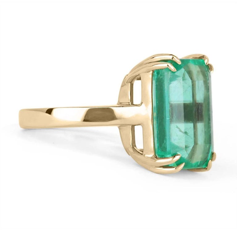 Behold this stunning 10.58-carat Colombian emerald solitaire ring. The large, natural, Colombian emerald weighs a full 10.58-carats. The gem showcases a gorgeous medium green color and almost perfect eye clarity with minor flaws; as these are