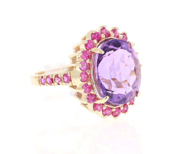 This ring has a Amethyst that weighs 9.49 carats and has 28 Pink Sapphires that weigh 1.37 carats. The total carat weight of the ring is 10.86 carats. 

The ring is crafted in 14 Karat Yellow Gold and weighs approximately 5.9 grams. 
The ring is a