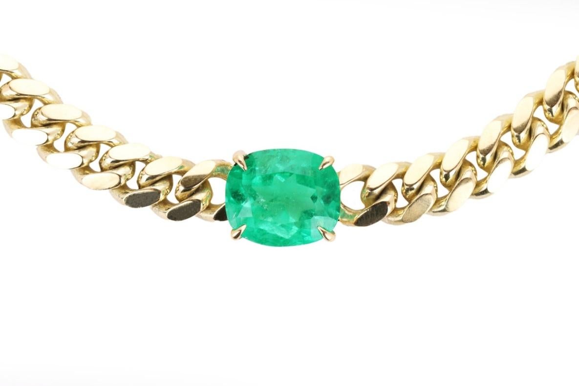 Featured here is a 10.86-carat stunning, emerald choker necklace in 14K yellow gold. Displayed in the center is a natural cushion cut Colombian emerald accented by a simple prong setting, allowing for the emerald to be shown in full view. The