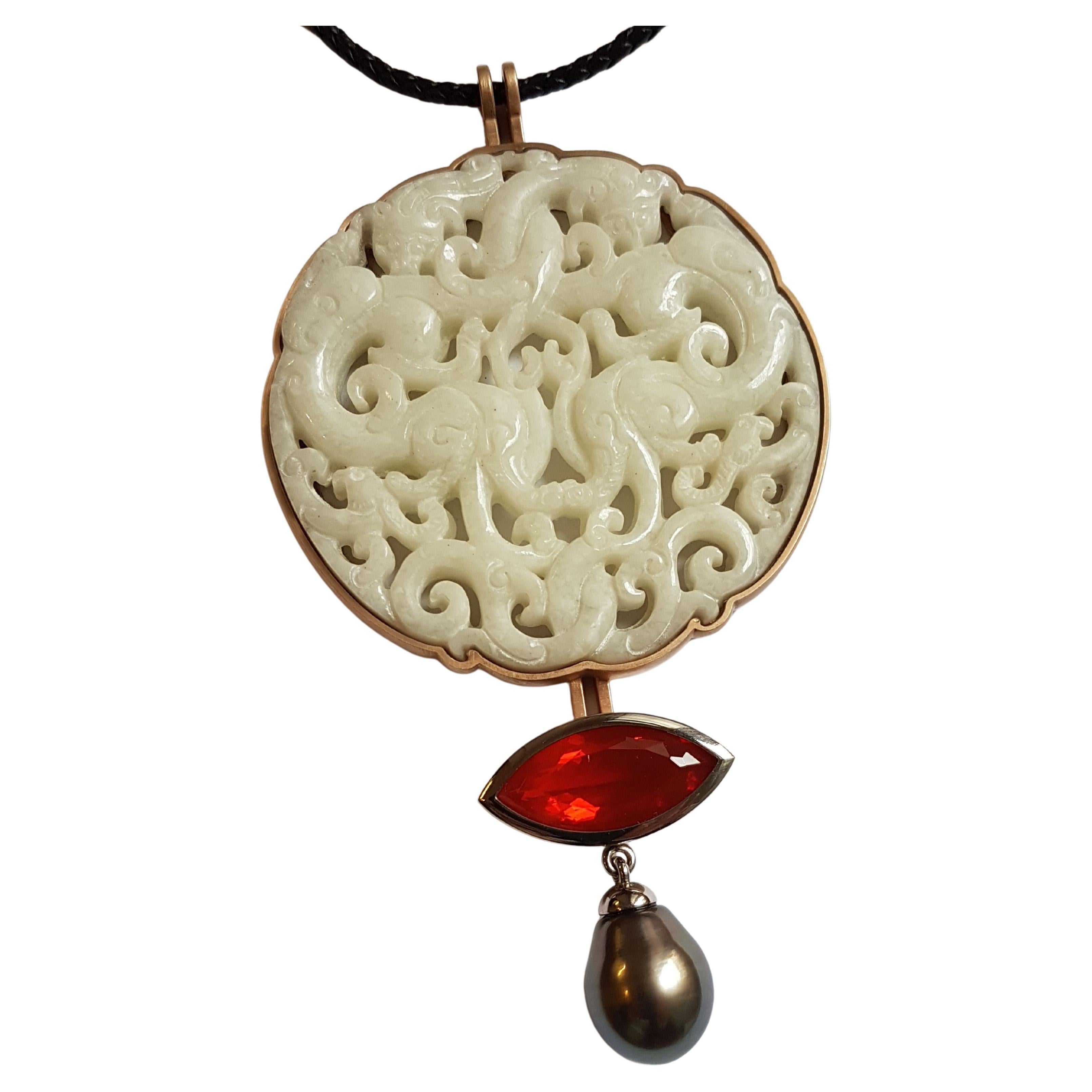 Elegant and casual at the same time - this beautiful necklace leaves nothing to be desired.
The white openworked historic chinese jade disc is surrounded by bronze and on the bottom complemented with a radiant 10.88 carat mexican fire opal navette