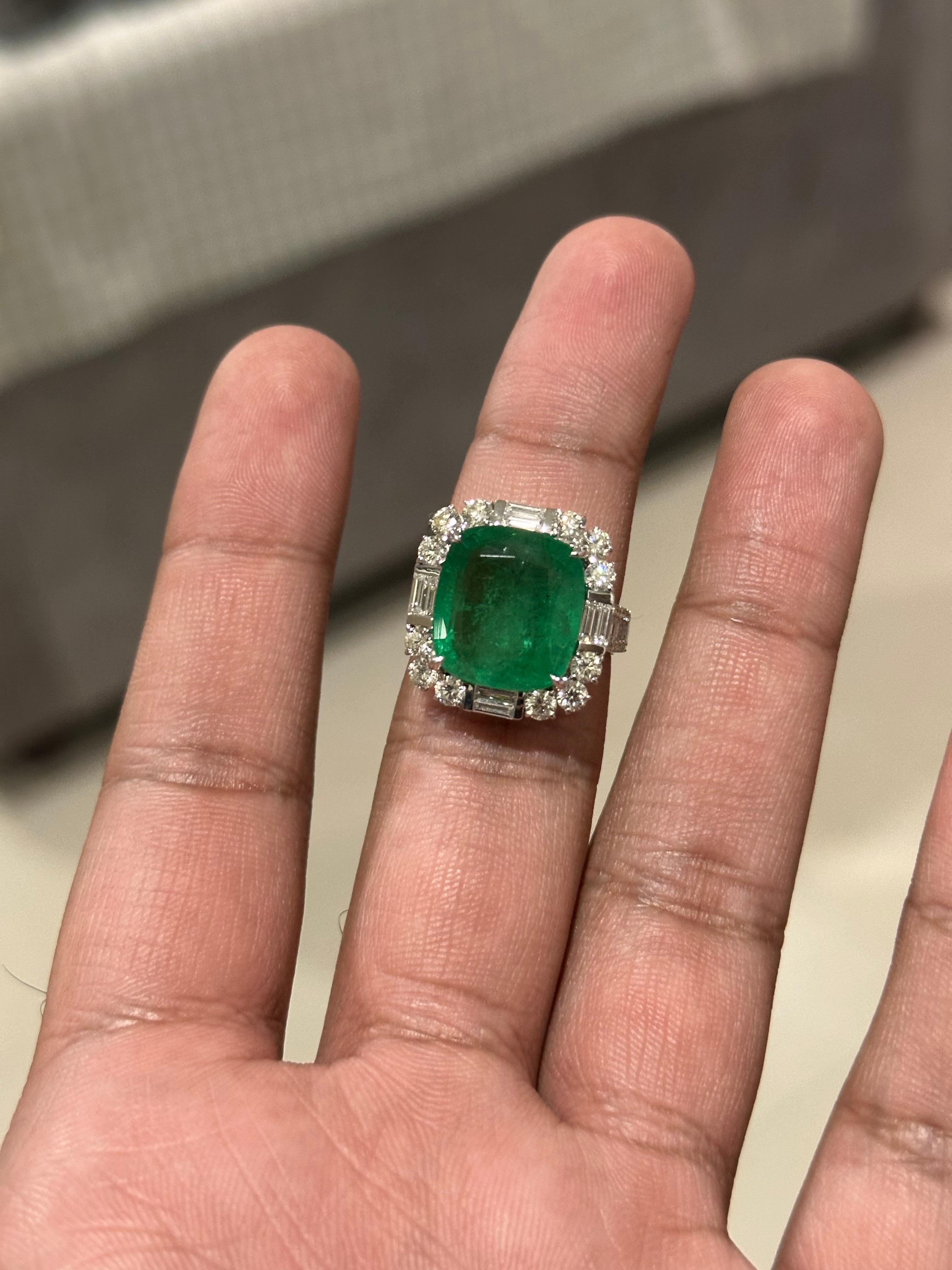 Bold, elegant, and masterfully crafted — this extraordinary cocktail ring is centered around a mesmerizing 10.88 carat Zambian emerald, known for its vivid green color and captivating depth. The emerald is natural and has undergone minor oil