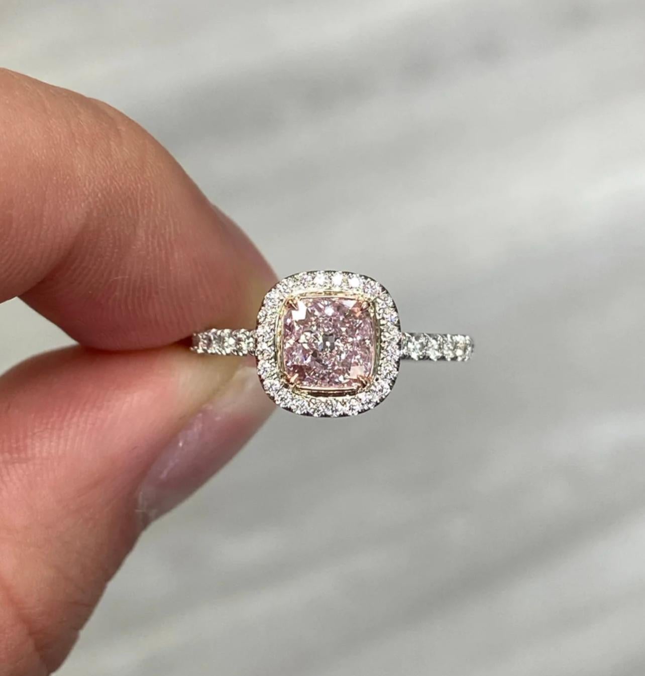 1.08 Carat 
GIA Certified Very Light Pink
Cushion Cut 
VS1 Clarity 
0.40 Carat White Diamonds 
Set in Platinum and Rose Gold in a diamond halo
Handmade in NYC 

Making Extraordinary Attainable with Rare Colors





