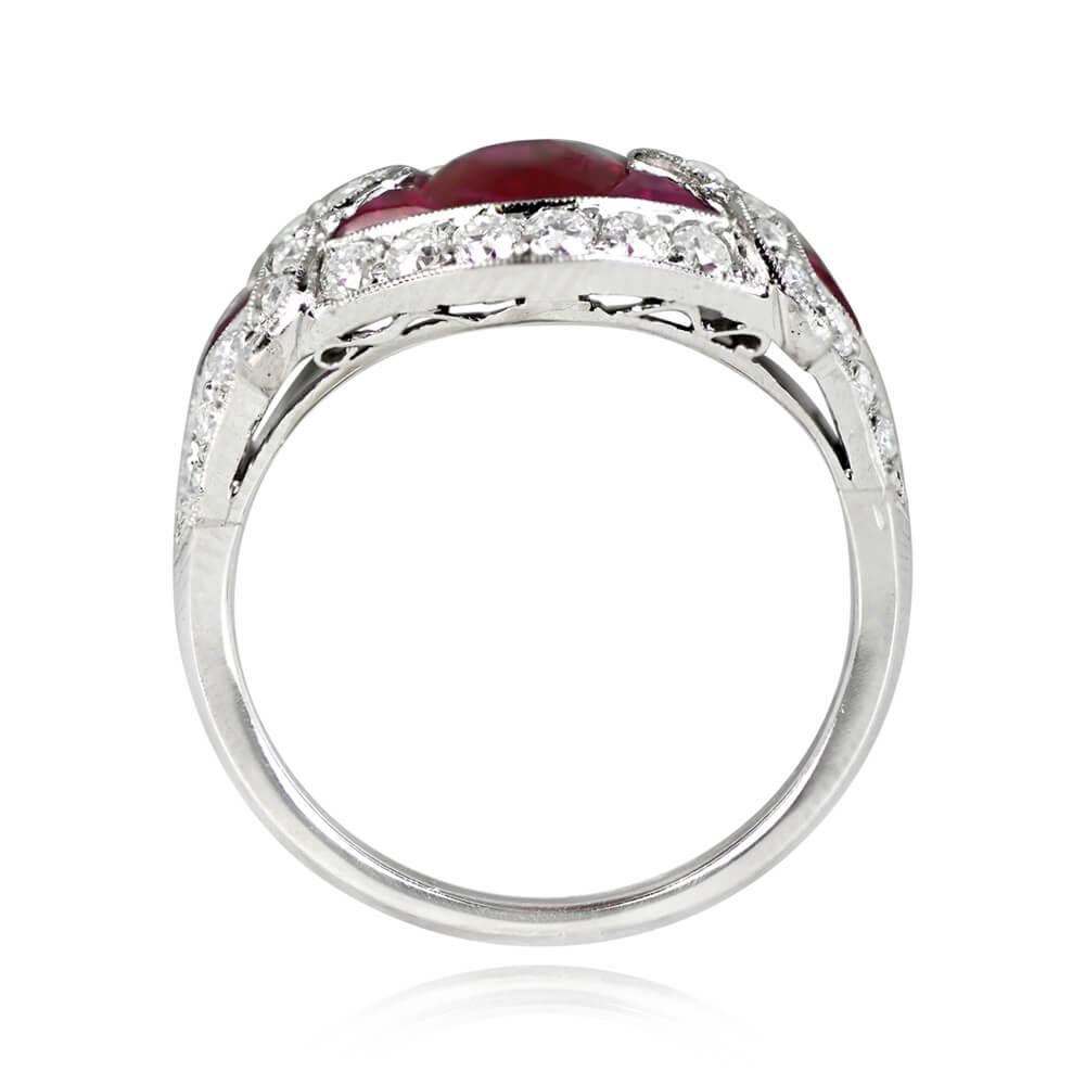 A captivating gemstone ring featuring a 1.08-carat oval cut natural ruby as the centerpiece. The striking design includes geometric arrangements of French cut rubies on either side, complemented by an old European cut diamond halo. Additional