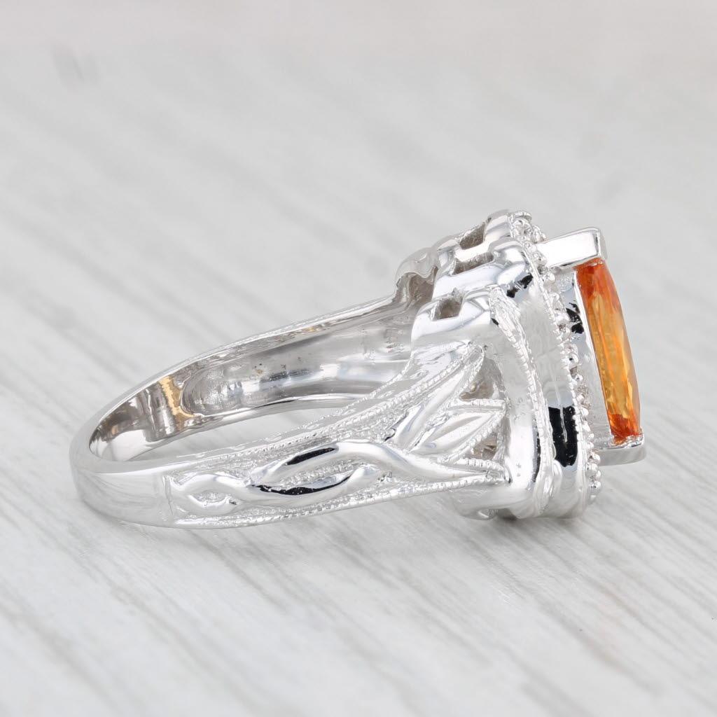 Gemstone Information:
- Natural Sapphire -
Carats - 1ct 
Cut - Marquise
Color - Orange
Treatment - Heated

- Natural Diamonds -
Total Carats - 0.08ctw
Cut - Round Brilliant
Color - F - G
Clarity - SI2 - I1

Metal: 14k White Gold
Weight: 6.2 Grams