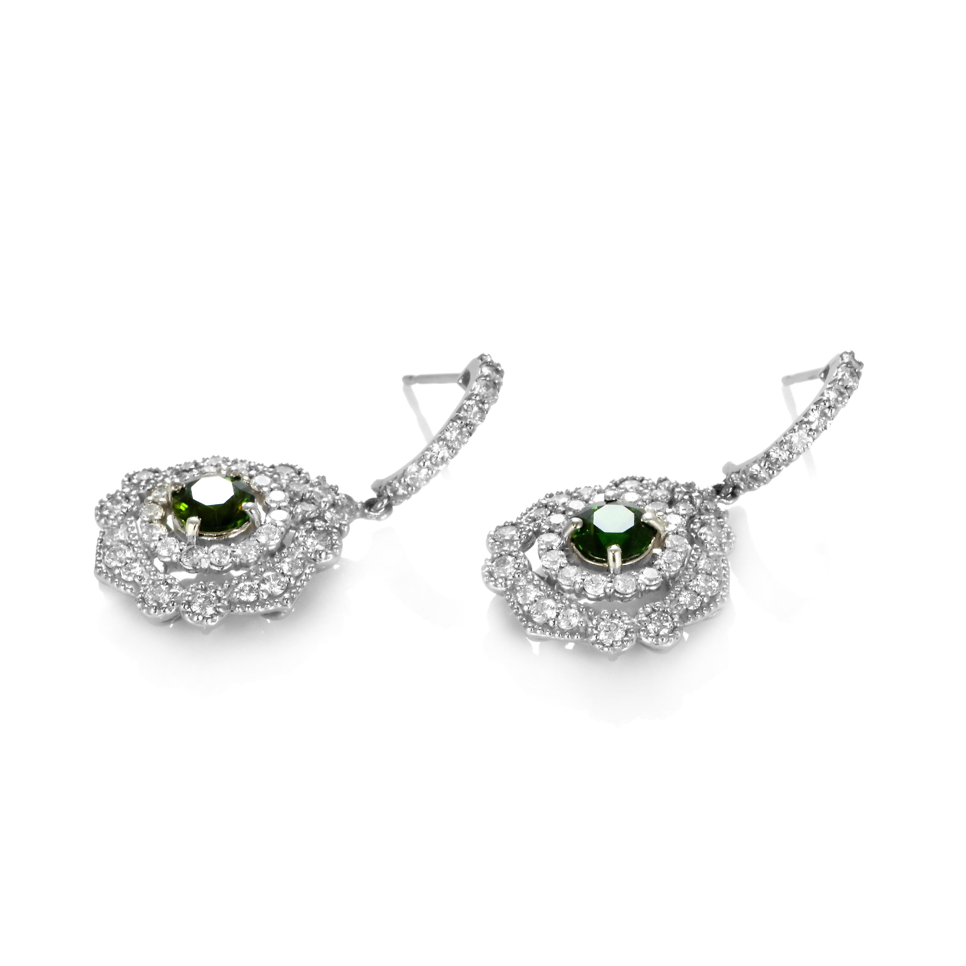 A beautiful earring featuring 1.09 Carats, Natural Demantoid Garnets and 1.34 Carats of Diamond Accents set in Platinum. Demantoid Garnet's only known source used to be the Ural Mountains in Russia however recent discoveries in Africa have allowed