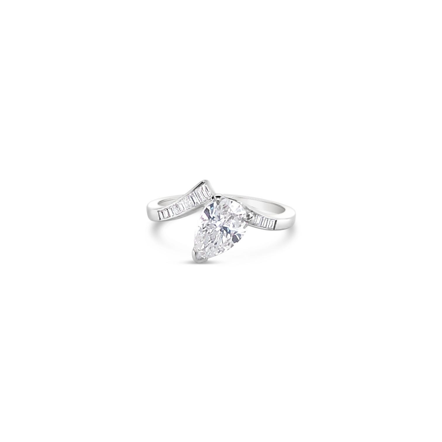 1.09 Carat Pear Shaped Diamond Ring with Baguette Side Diamonds set in 14 Karat White Gold.  Primary stone has Color G, Clarity SI2.  Side diamonds are 0.80 Carat 'total weight'.