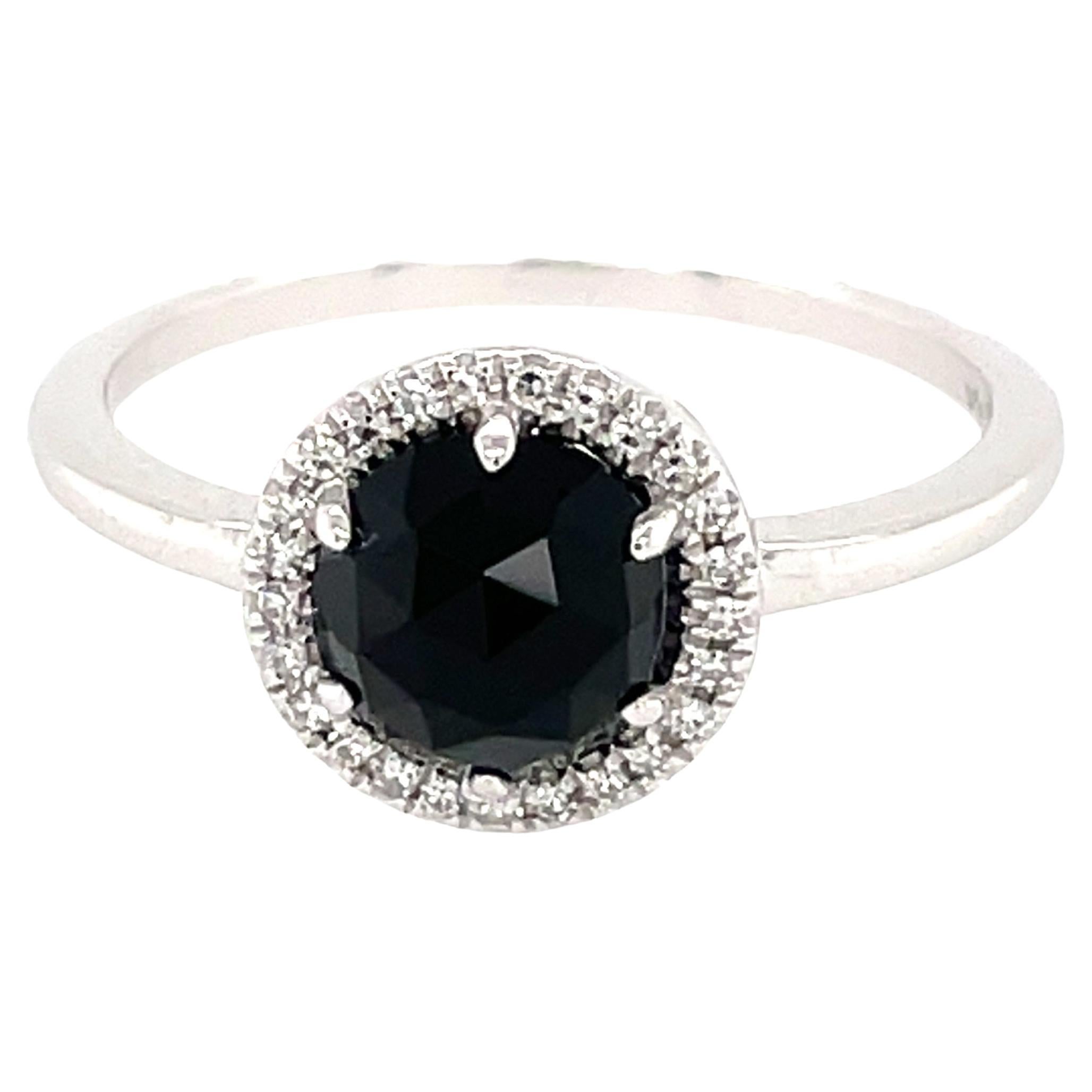 This Black Onyx & Diamond Ring is a stunning and timeless accessory that can add a touch of glamour and sophistication to any outfit. 

This ring features a 1.09 Carat Black Onyx, with a Diamond Halo comprised of 0.06 Carats of Single Cut Round