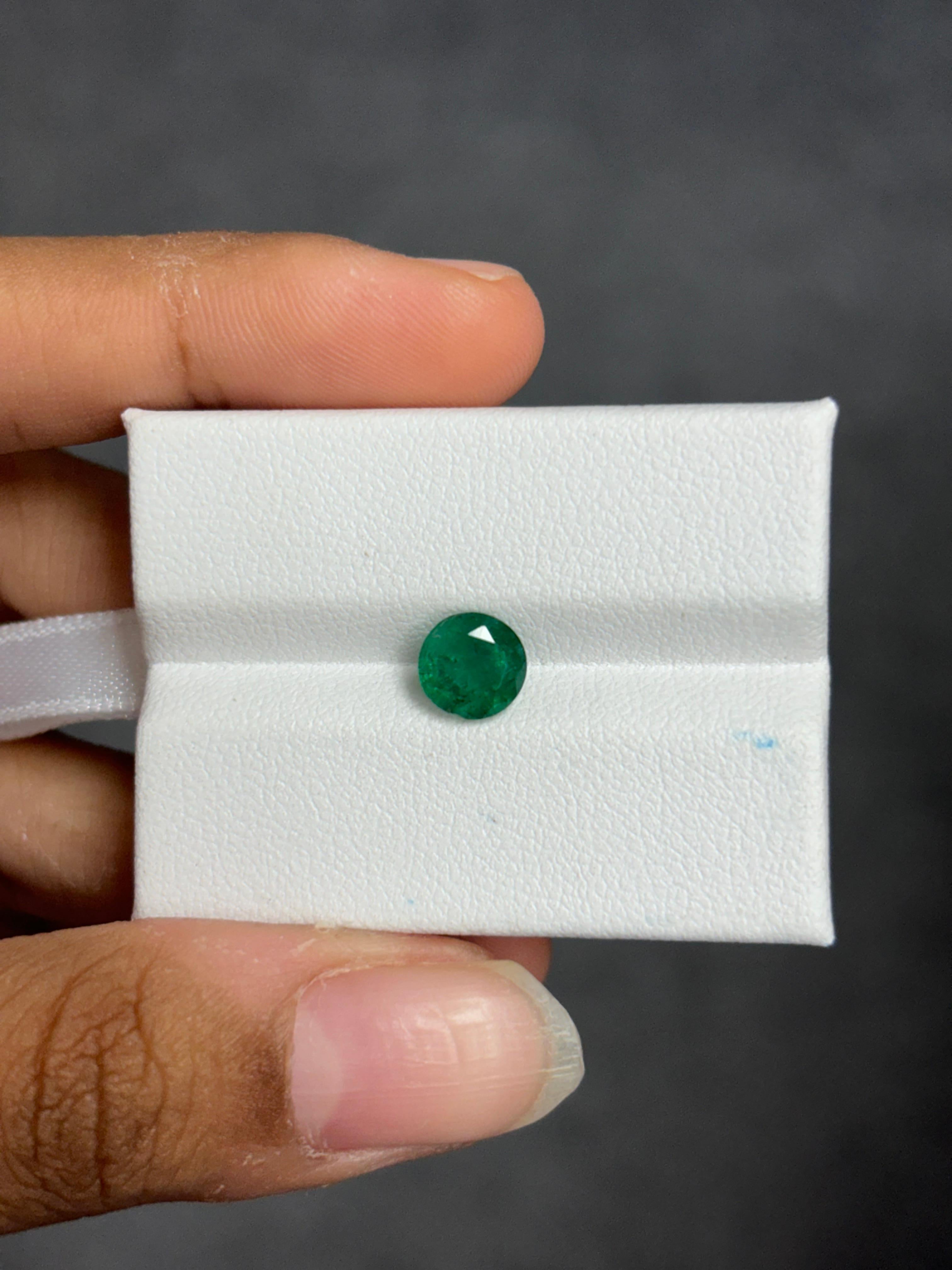 A stunning 1.09 Carat Emerald stone that is a gorgeous shade of vivid green and originates from Zambia. It is completely natural and of good quality. The emerald piece is cut into perfection in a round-cut shape.

The green emerald has only
