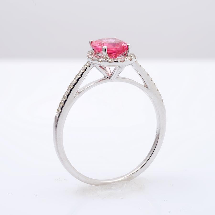 This evenly colored neon pink Tanzanian Spinel gives this ring the instant burst of color it needs. With the light hitting the gem in all the right angles, this stone is both brilliant and lustrous. Weighing 1.09 carats, the oval cut gem is a