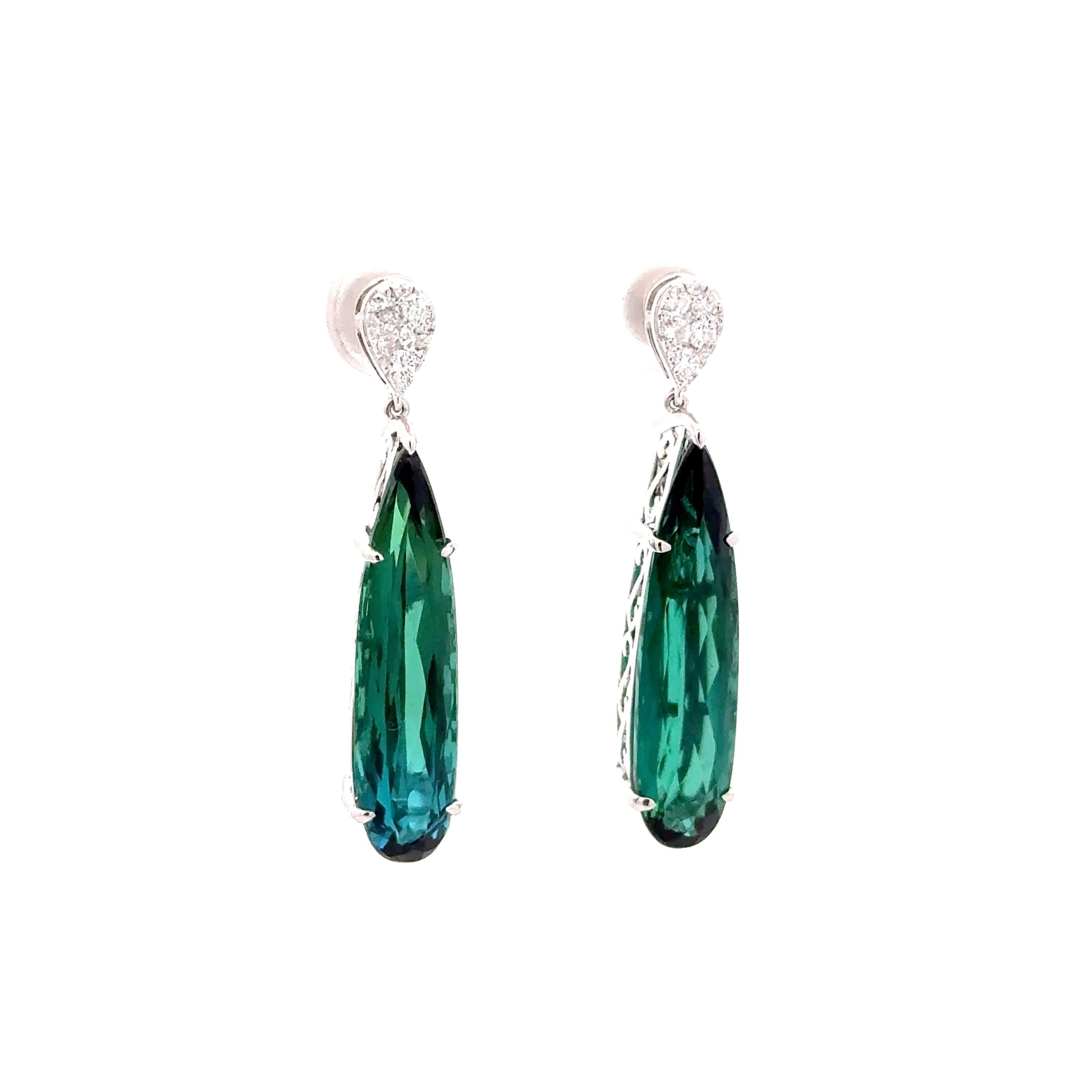 Realizzati in oro bianco 14 carati, questi eleganti orecchini a goccia sono un'aggiunta straordinaria a qualsiasi collezione. Con 10,90 carati di indicoliti a forma di goccia di qualità superba e dall'accattivante colore verde-blu. Il design è