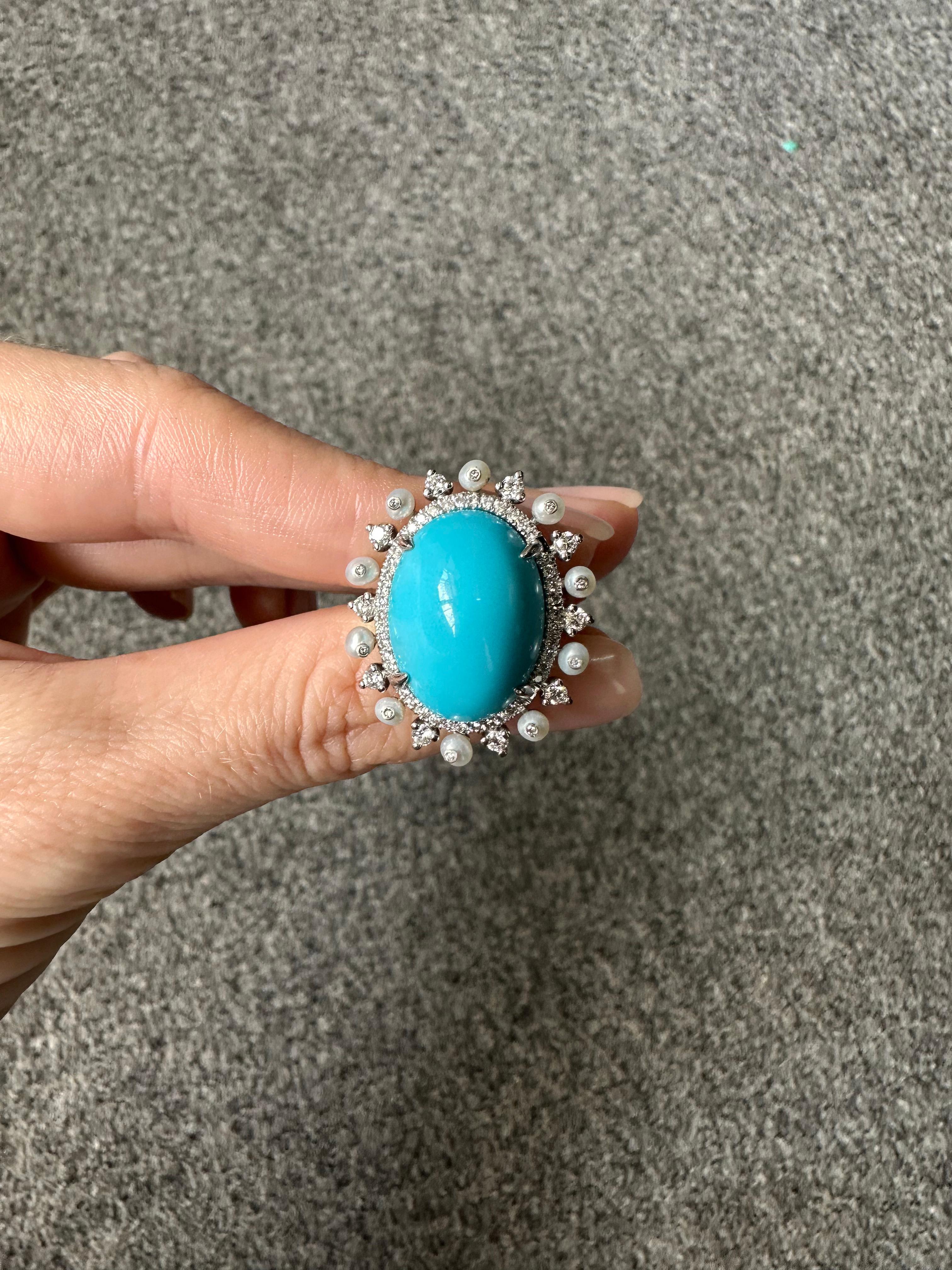 a beautifully handcrafted 10.92 carat Arizonian Turquoise and Pearl Ring, with White Diamonds surrounding the Turquoise and making the pearls stand out. Set in 18K White Gold. Earrings and pendant are available. Currently sized at US7, can be