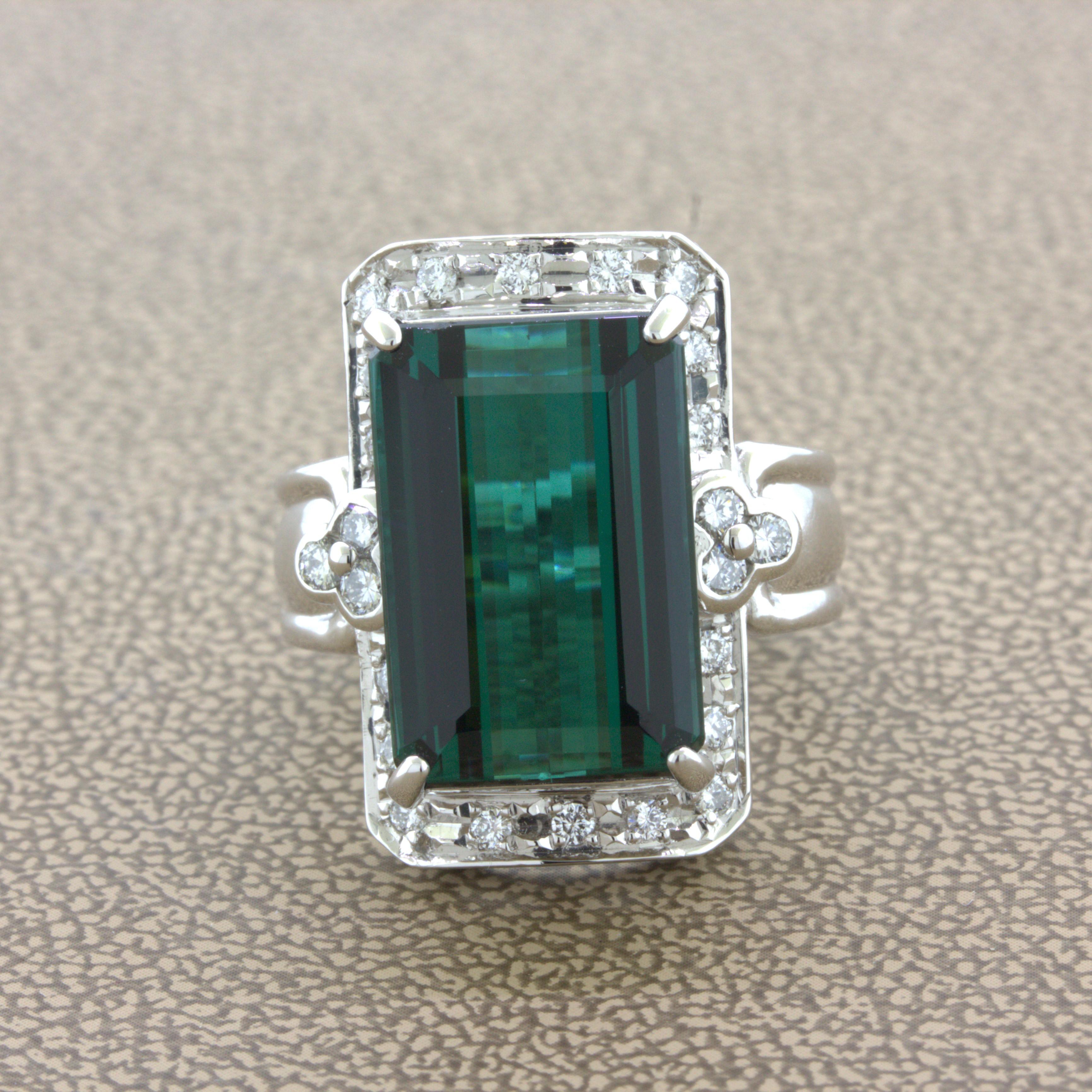 A fine neon blue-green indicolite tourmaline takes center stage of this platinum made cocktail ring. The tourmaline weighs an impressive 10.92 carats and has a sweet sharp and clean classic blue-green indicolite color. It is complemented by 0.40