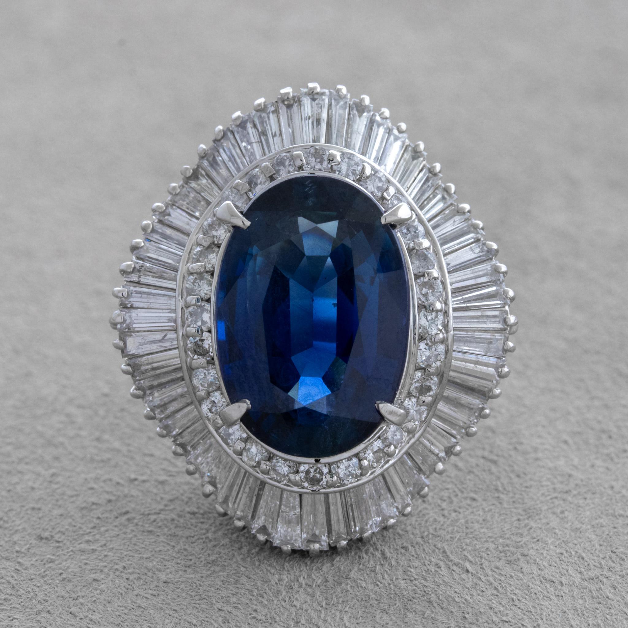 A large and impressive sapphire weighing an impressive 10.92 carats takes center stage! It is oval-shaped and has a rich open blue color and is very clean as it has no eye visible inclusions. It is complemented by an array of diamonds weighing 2.72