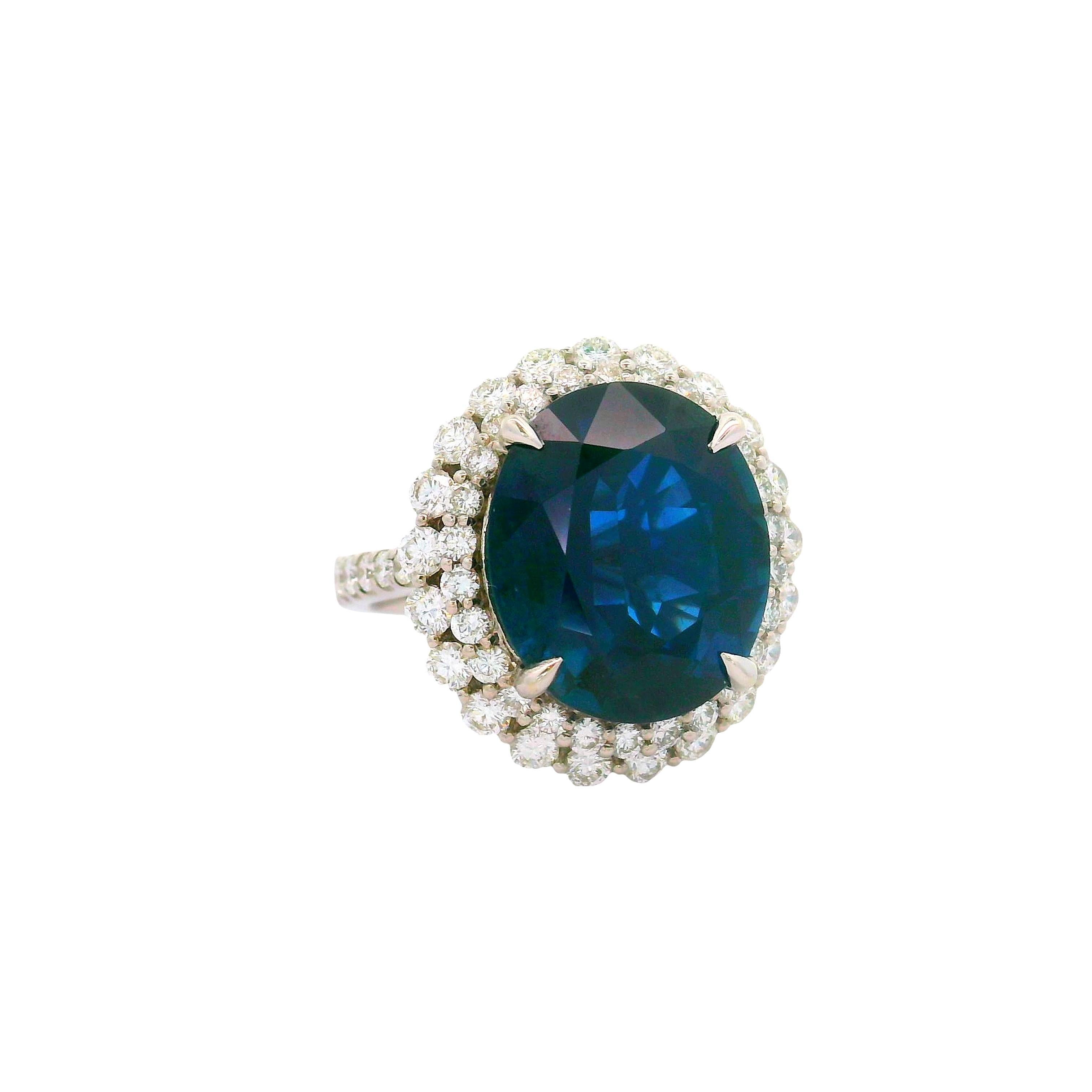 Exquisite craftsmanship. This fashion ring features a stunning 10.95 carat oval blue sapphire, radiating deep blue hues. Encircling the sapphire is a halo of round-cut white diamonds, totaling 1.67 carats, adding brilliance and elegance. Crafted in