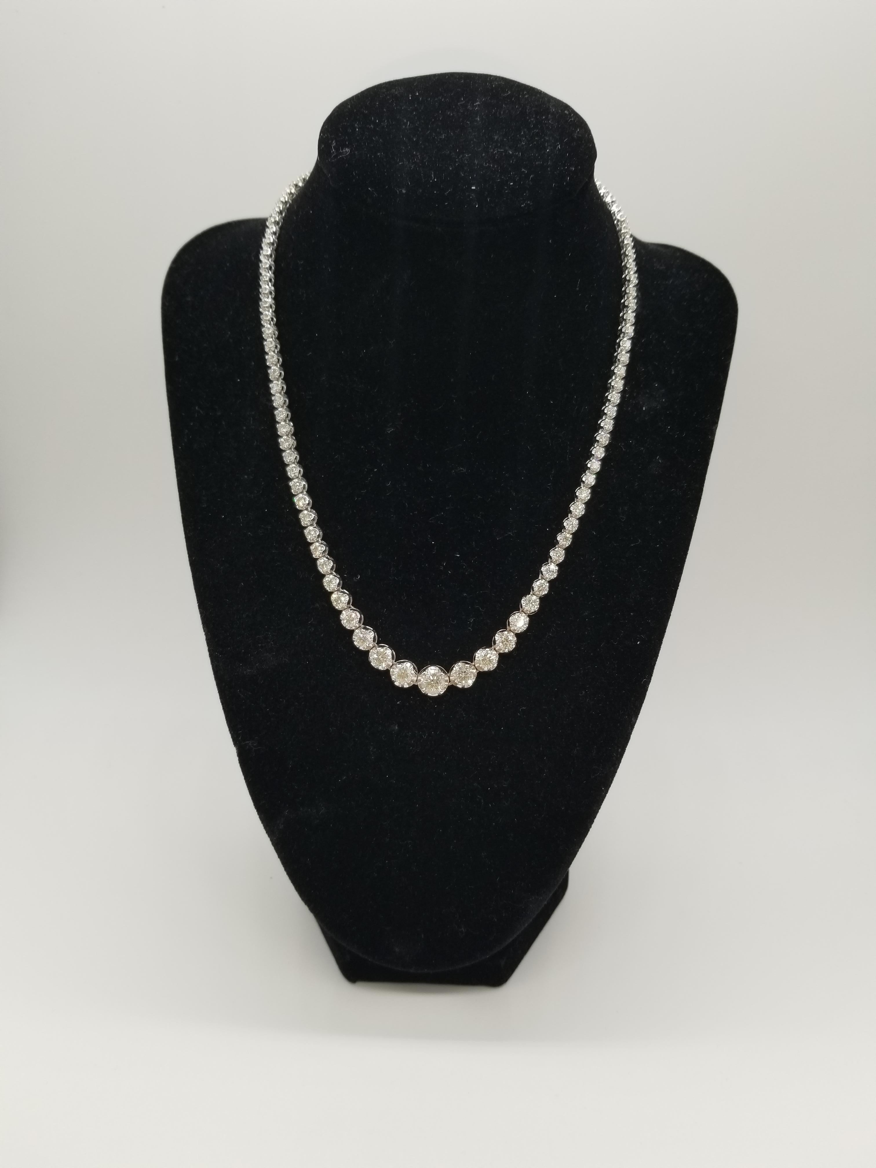 Stunning 14 Karat White Gold Round Brilliant Cut Diamond Tennis Necklace set on 4- prong buttercup setting. The total diamond weight is 10.90 carats. The closure is an insert clasp with safety clasp. Length is 16 inches. center stone from 1 ct to