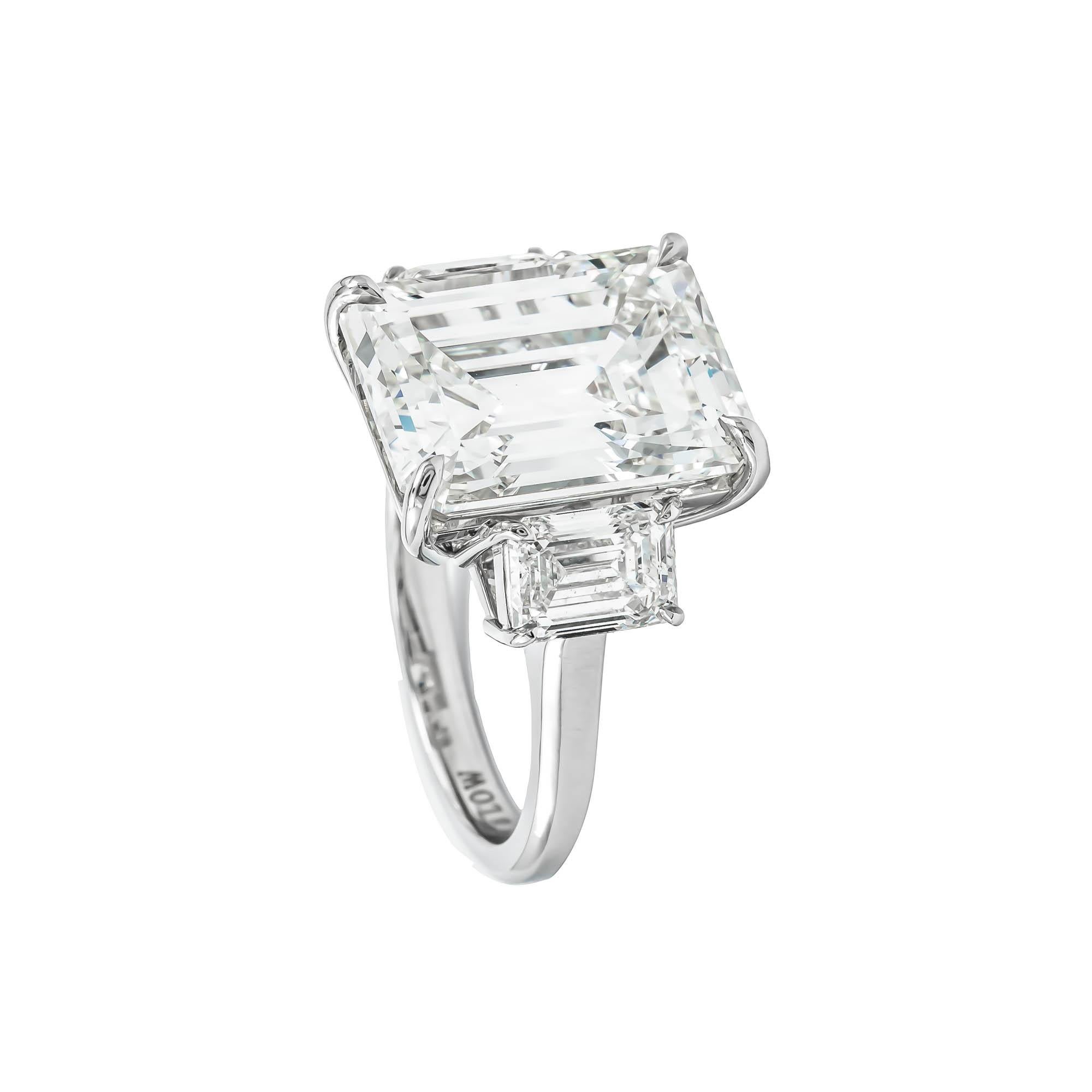 Platinum custom made Emerald Cut Diamond three stone ring. Consisting of one center Diamond weighing  10.75 Carat Emerald Cut Diamond with a color and clarity grade of K VS 2 GIA #6197826516 measurements 14.35 x 11.08 x 7.43 mm, flanked by 2