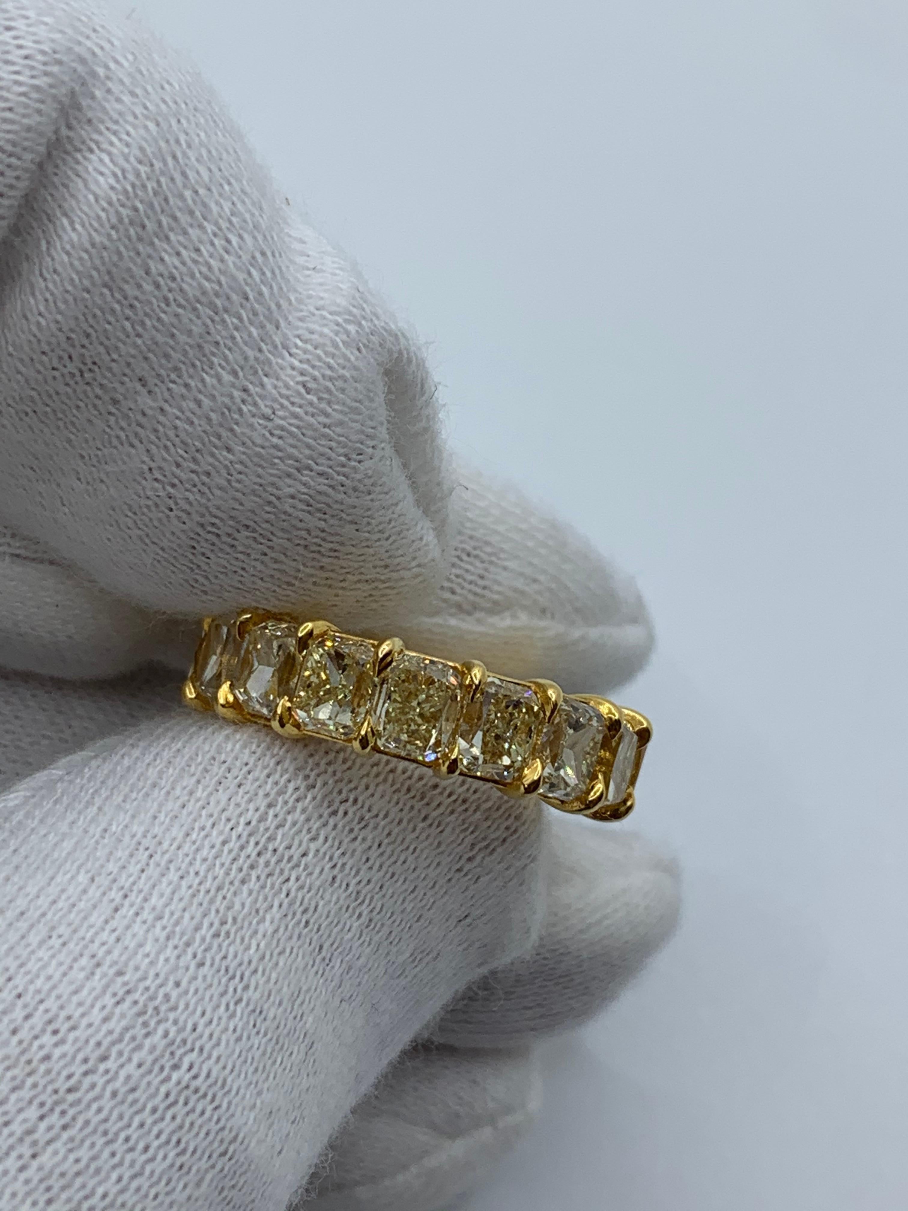 This Eternity Ring features 17 perfectly matched Radiant Cut Fancy Yellow Diamonds weighing 10.96 Carats. Average is 65 Points each.
Diamonds are of VS Clarity.
Set in 18 Karat Yellow Gold.
Size 6.25