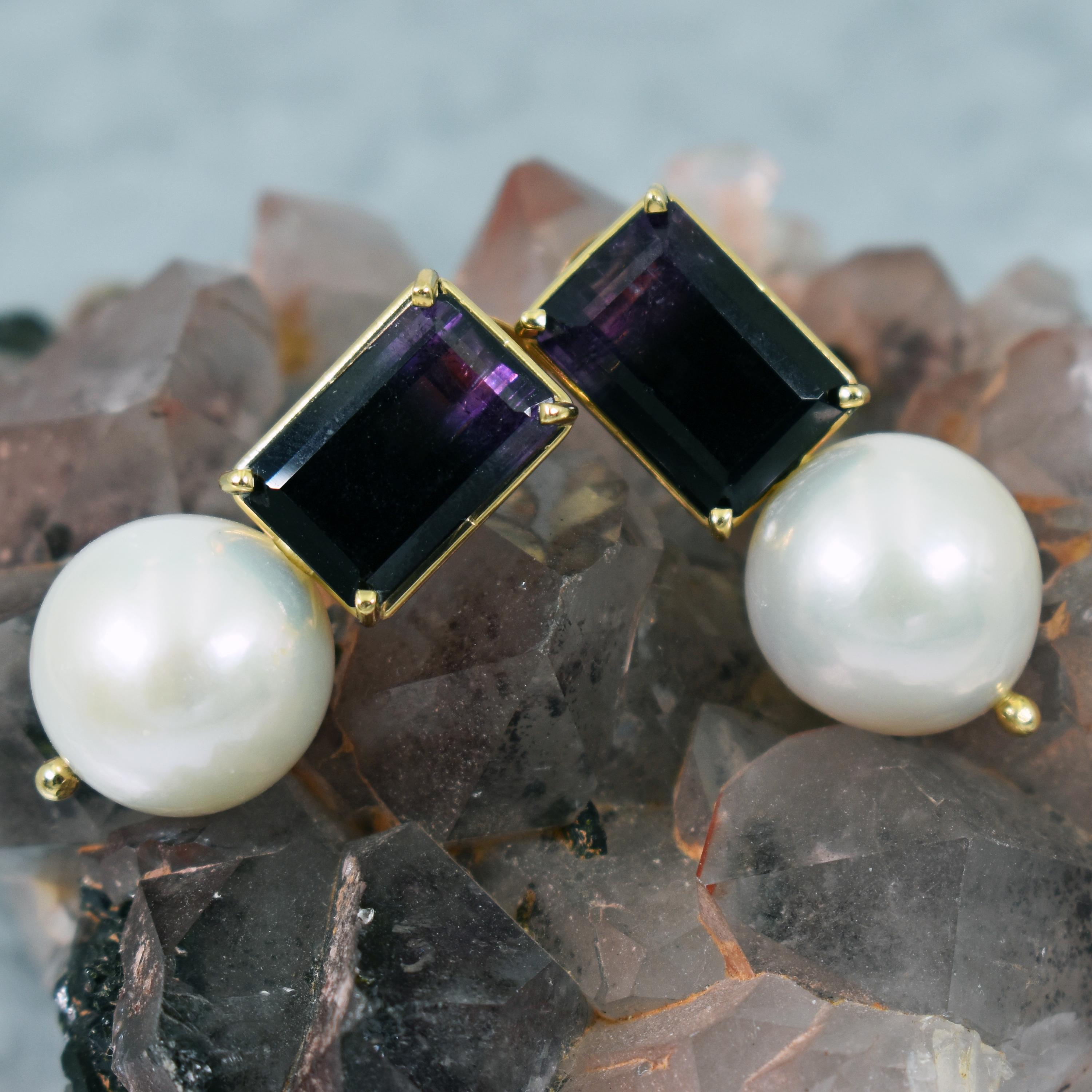 10.97 carat emerald-cut Blue John Fluorite and round, white 14mm Freshwater Pearl drop 14k yellow gold stud earrings. Stud earrings are 1.25 inches or 32mm in length. Gorgeous, deep purple gradient ombré Blue John Fluorite and Pearl gemstones make