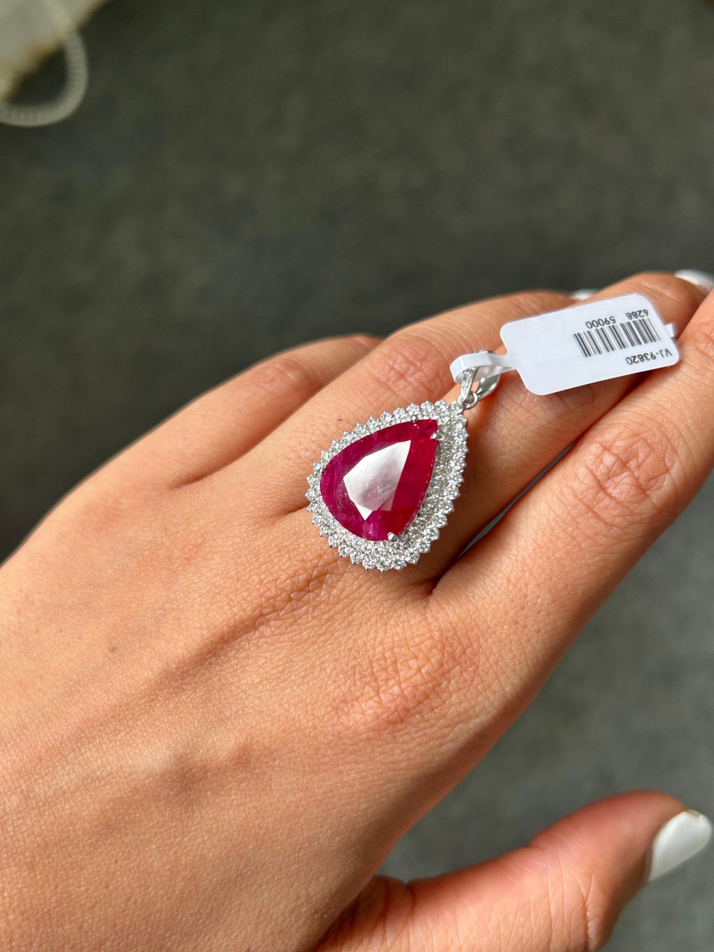 Make a statement by wearing this stunning pear shape, 10.98 carat natural Mozambique Ruby pendant, surrounded by 1.45 carat White Diamonds, set in solid 18K White Gold. The pendant comes without a chain, but can be added. We can convert this pendant