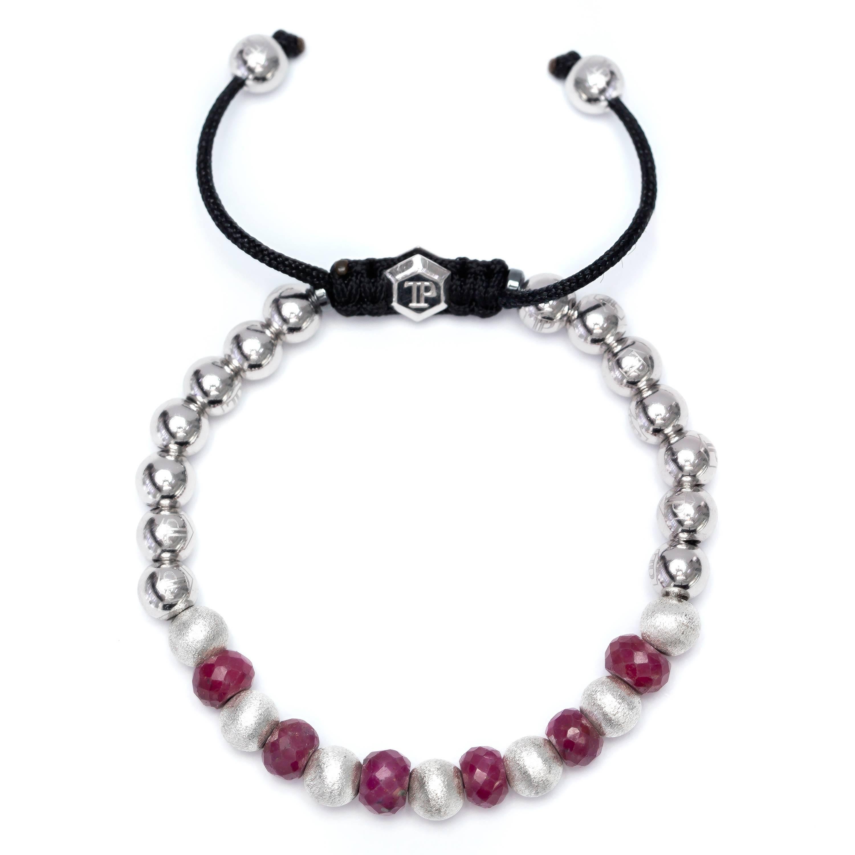 This 10.98 Ruby Stainless Steel and Silver beaded Macrame bracelet from The OriginalTresor Paris Audace Collection features 7 satin beads and 14 shiny Stainless Steel beads and two magnetite rings with a Silver Hexagon Logo. Size will fit from 7' to