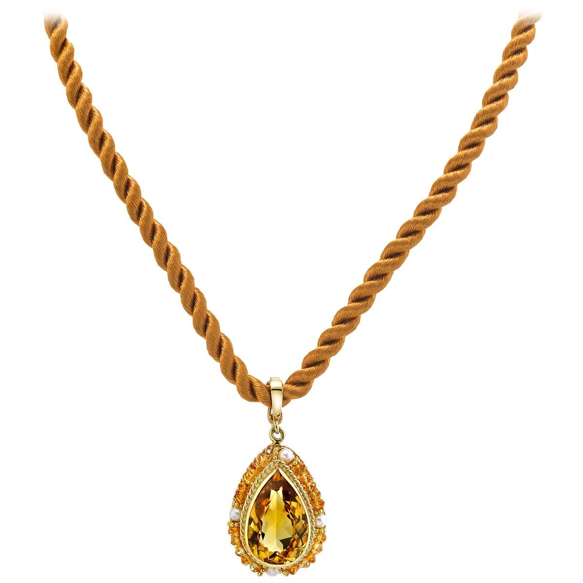 This beautiful pendant features a golden pear shaped citrine encircled by citrine beads and pearls. The pendant is entirely hand made of 18 karat yellow gold wire using a gold wire filigree technique rarely seen today. The jeweler who made this
