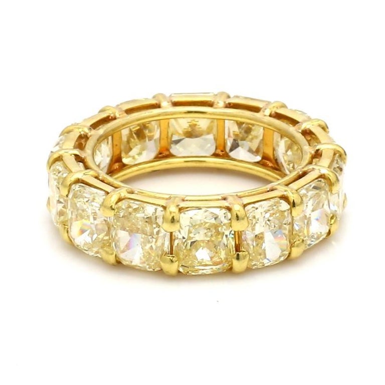 For sale is an 18K yellow gold 10.98ctw cushion cut fancy yellow diamond eternity band ring.

STONES: 14 FY VS1 Cushion Cut Diamonds (10.98ctw)

METAL: 18K Yellow Gold

GRAMS: 6.00

SIZE: 6

REFERENCE NUMBER: BD0345