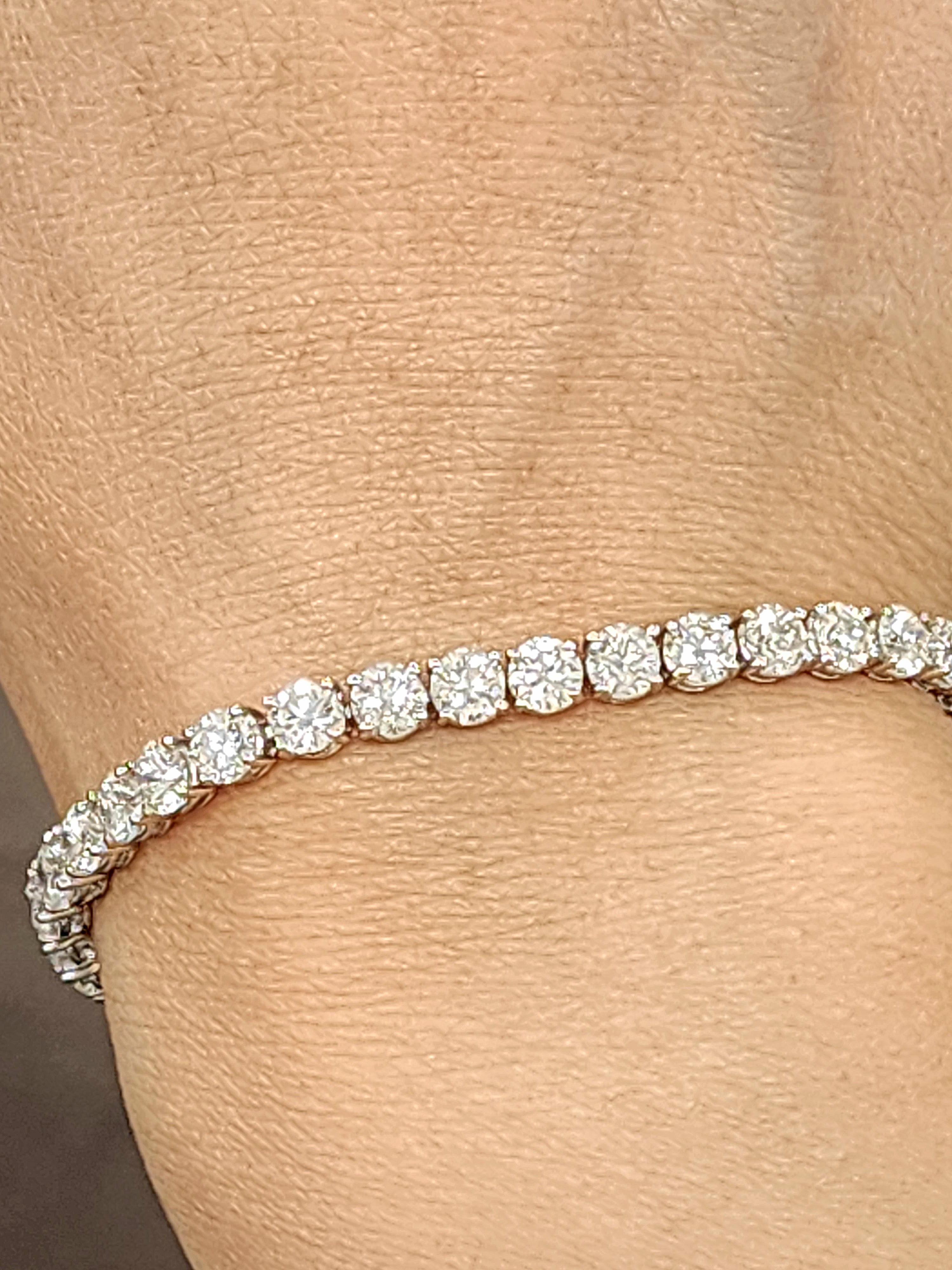 This gorgeous bracelet features 42 round-cut diamonds totaling 10.99 carats. The diamonds are white, with a clarity of VS2/SI1 and a color grade of F/G. Crafted in platinum, this modern piece measures 7.0 inches in length. A timeless addition to any