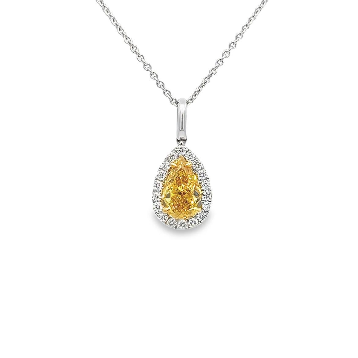 Get your hands on a truly unique piece of jewelry - a stunning 0.90ct Fancy Vivid Orangy Yellow pear-shaped diamond pendant, certified by GIA with an SI2 clarity rating. This rare Diamond is beautifully complemented by a ring of round brilliant