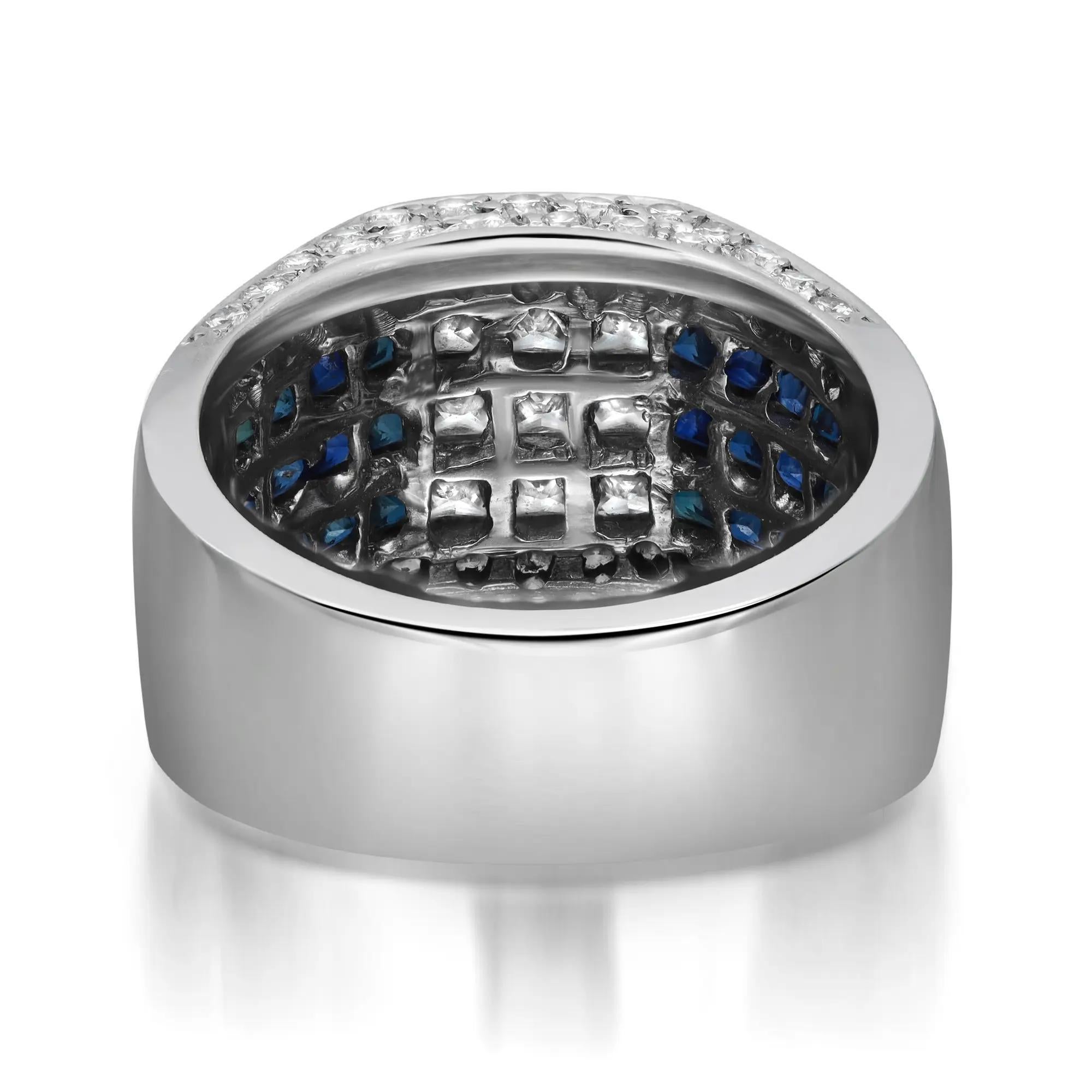 This bold and dramatic cocktail band ring features channel set dazzling princess cut diamonds in the center with channel set princess cut blue sapphires on both sides. Accented with pave set round brilliant cut diamonds on the edges which enhances