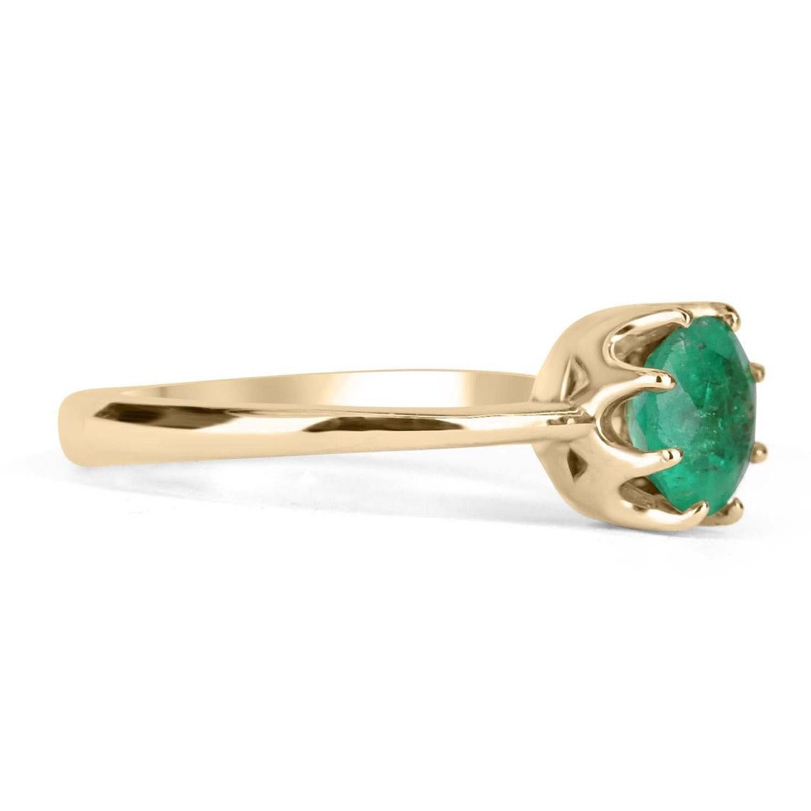 Displayed is a classic emerald 8 prong solitaire, round-cut, vintage ring in 14K yellow gold. This gorgeous solitaire ring carries a full 1.0-carat emerald in a 8-prong setting. Fully faceted, this gemstone showcases excellent shine. The emerald has