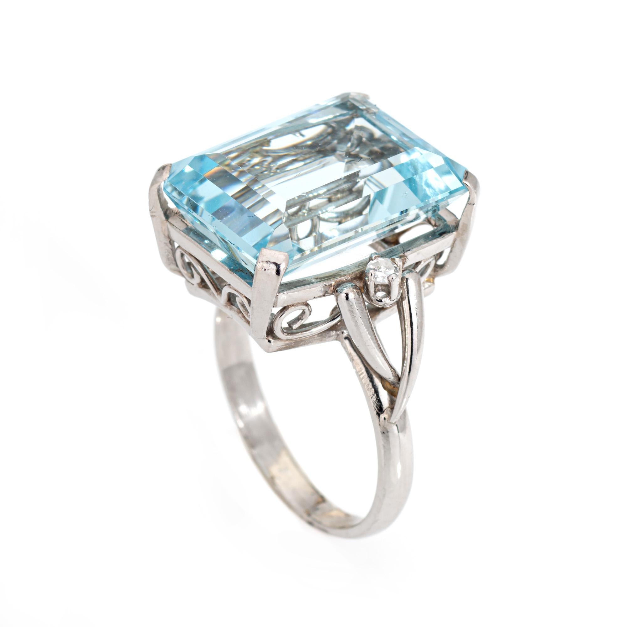 Stylish vintage aquamarine & diamond cocktail ring (circa 1960s to 1970s) crafted in 900 platinum. 

Emerald cut aquamarine measures 16mm x 12mm (estimated at 10 carats), accented with 2 single cut diamonds that total an estimated 0.04 carats