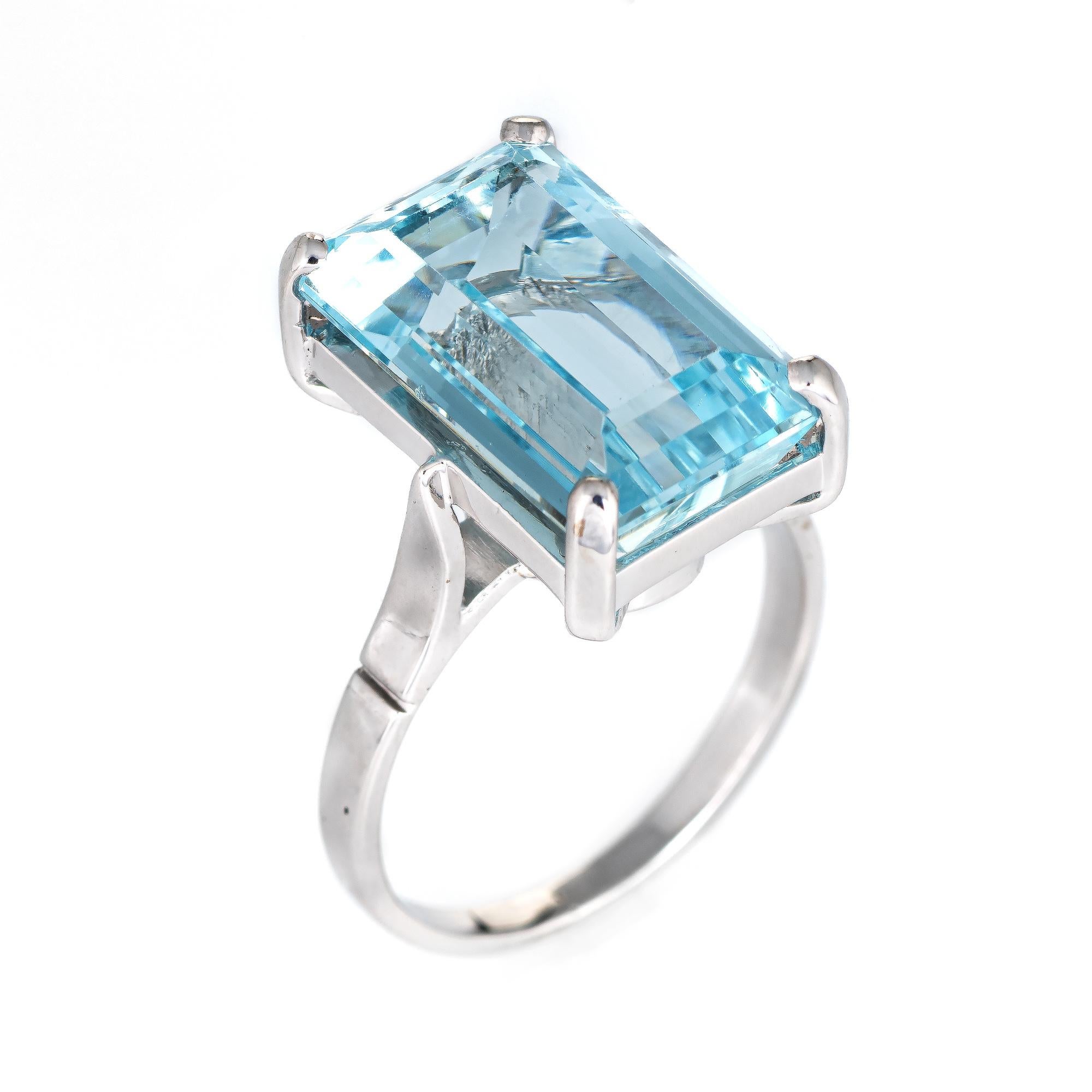 Stylish blue topaz cocktail ring crafted in 18 karat white gold. 

Emerald cut blue topaz measures 15mm x 9.5mm (estimated at 10 carats). The topaz is in excellent condition and free of cracks or chips. 

The topaz is set securely in a four pronged