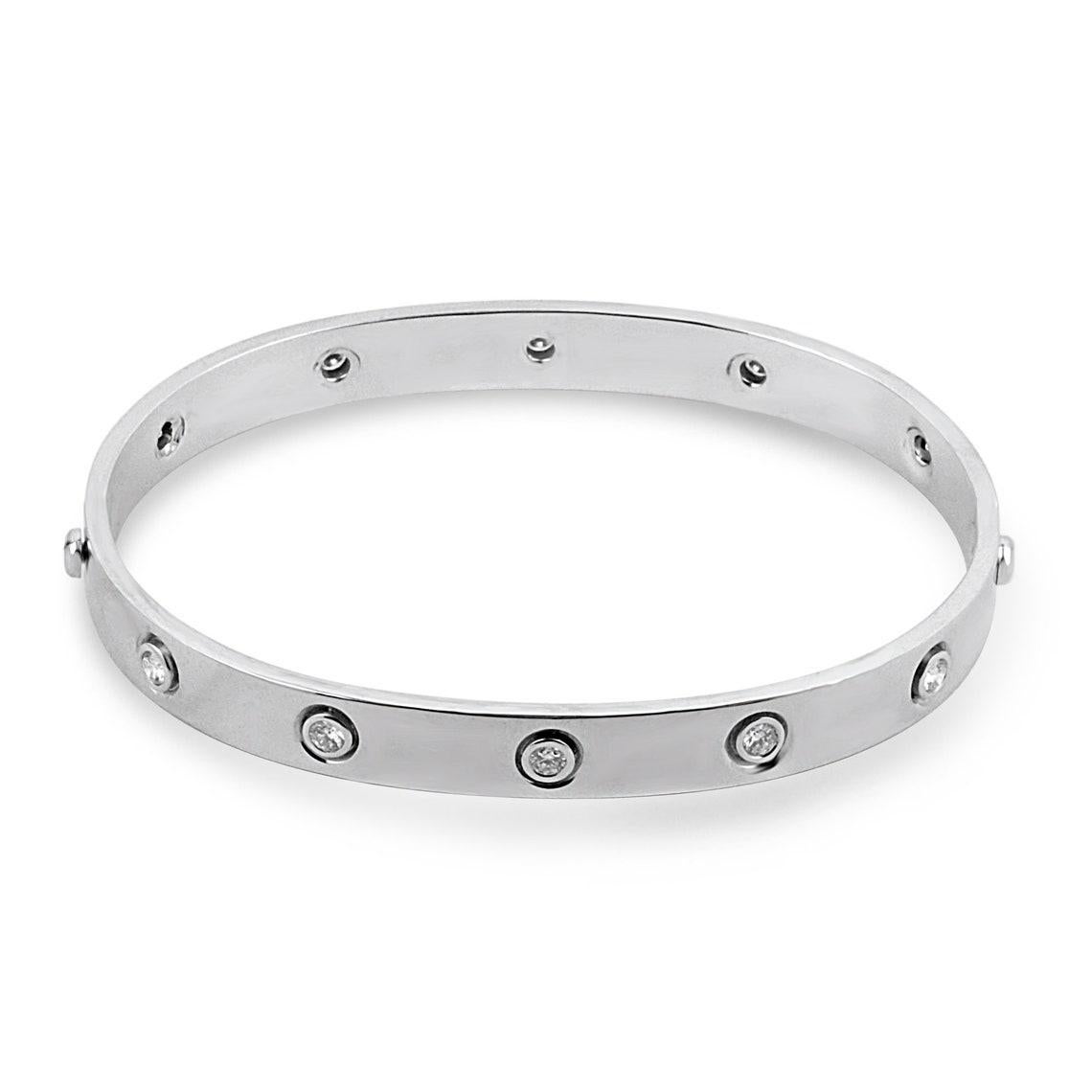 Showcased is a stunning, diamond bangle bracelet. 10 stunning diamonds go around the bangle, evenly spaced out and securely bezel set in an 18K white gold setting. This bracelet resembles the infinite power of love, within ourselves and the