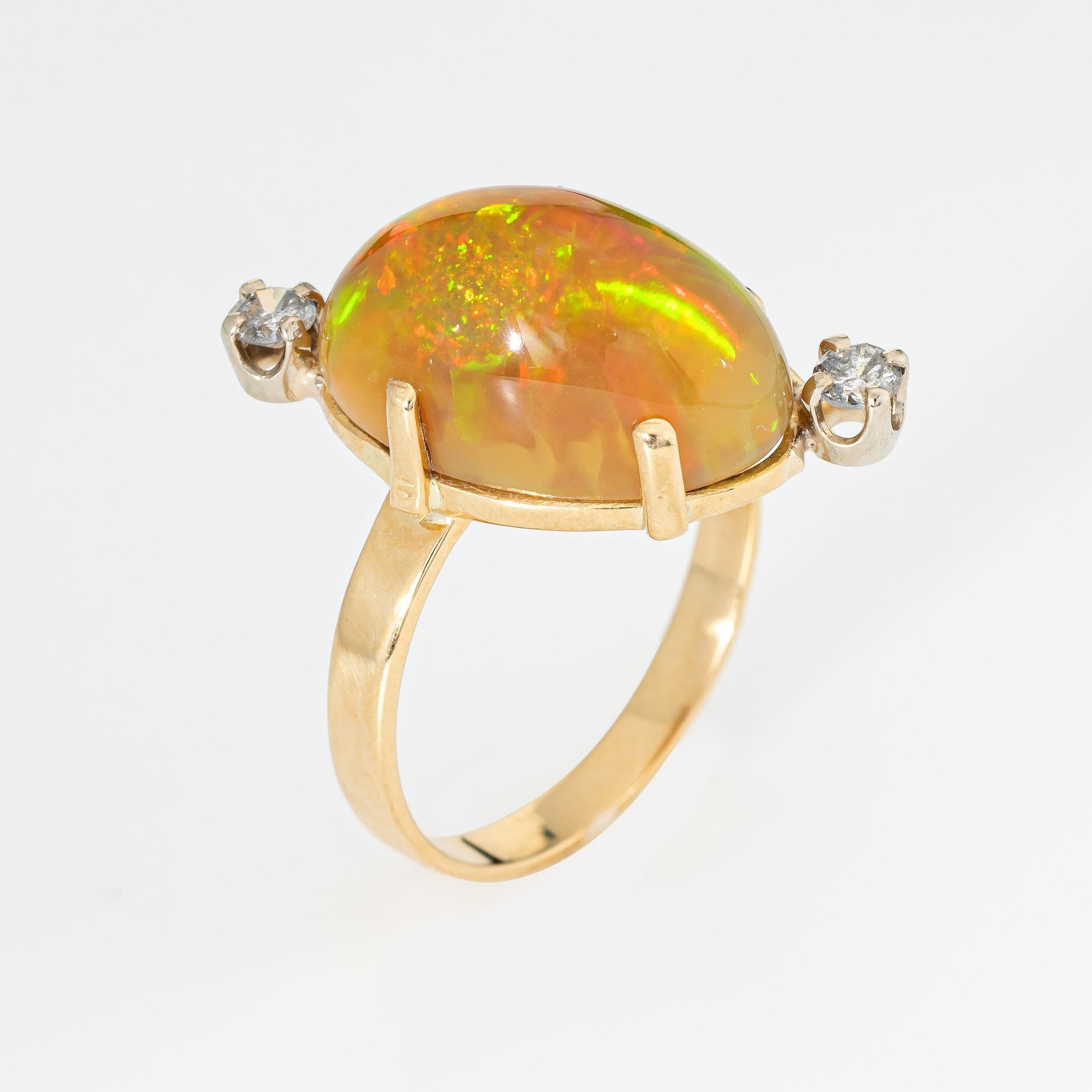 Stylish vintage Ethiopian opal & diamond cocktail ring crafted in 18 karat yellow gold (circa 1960s to 1970s).

Natural opal is at estimated at 10 carats, accented with two estimated 0.08 carat diamonds. The total diamond weight is estimated at 0.16