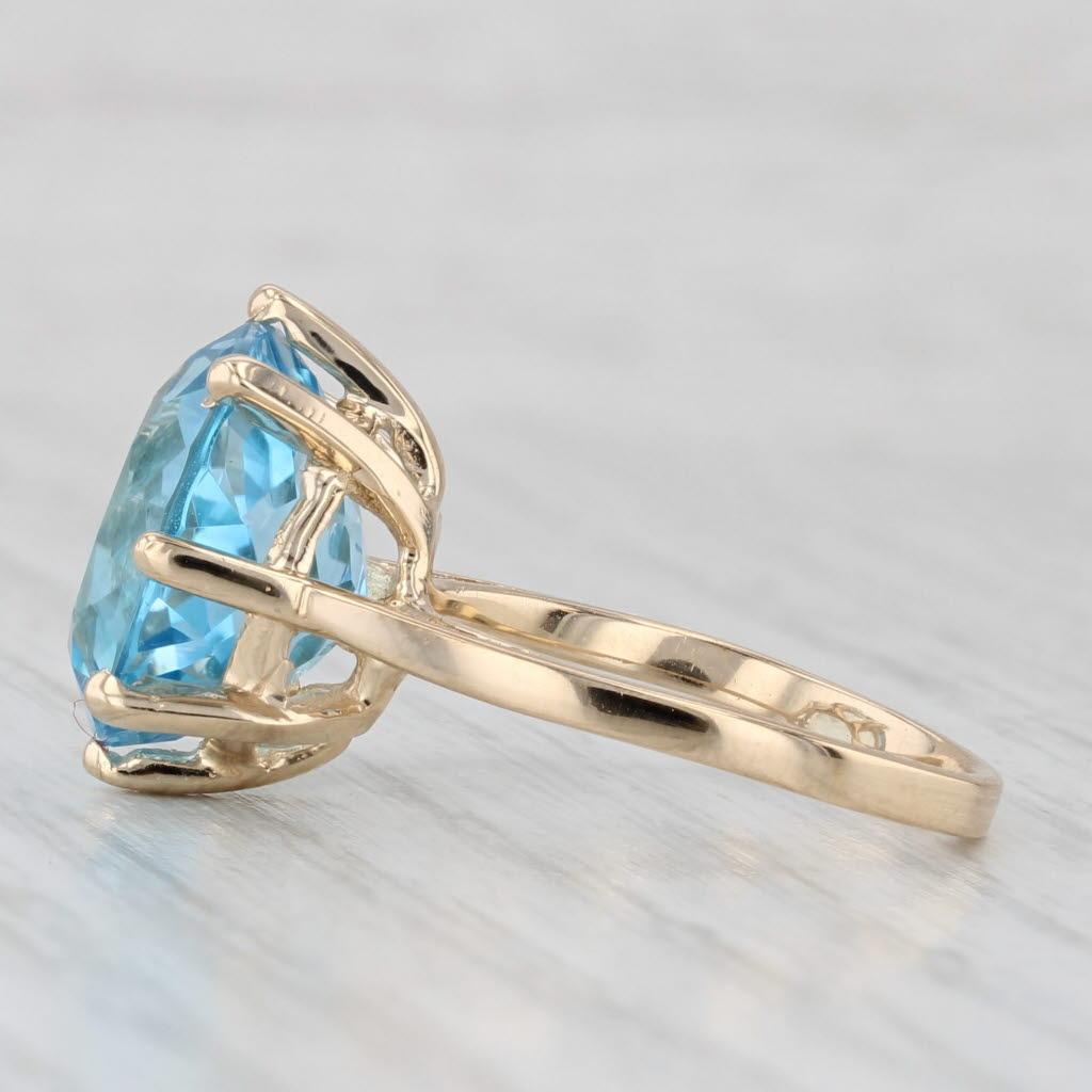 Gemstone Information:
- Natural Topaz -
Carats - 10ct 
Cut - Round
Color - Light Blue
Treatment - Routinely Enhanced

Metal: 14k Yellow Gold 
Weight: 5.3 Grams 
Stamps: 14k
Face Height: 15.3 mm 
Rise Above Finger: 9 mm
Band / Shank Width: 2 mm

This