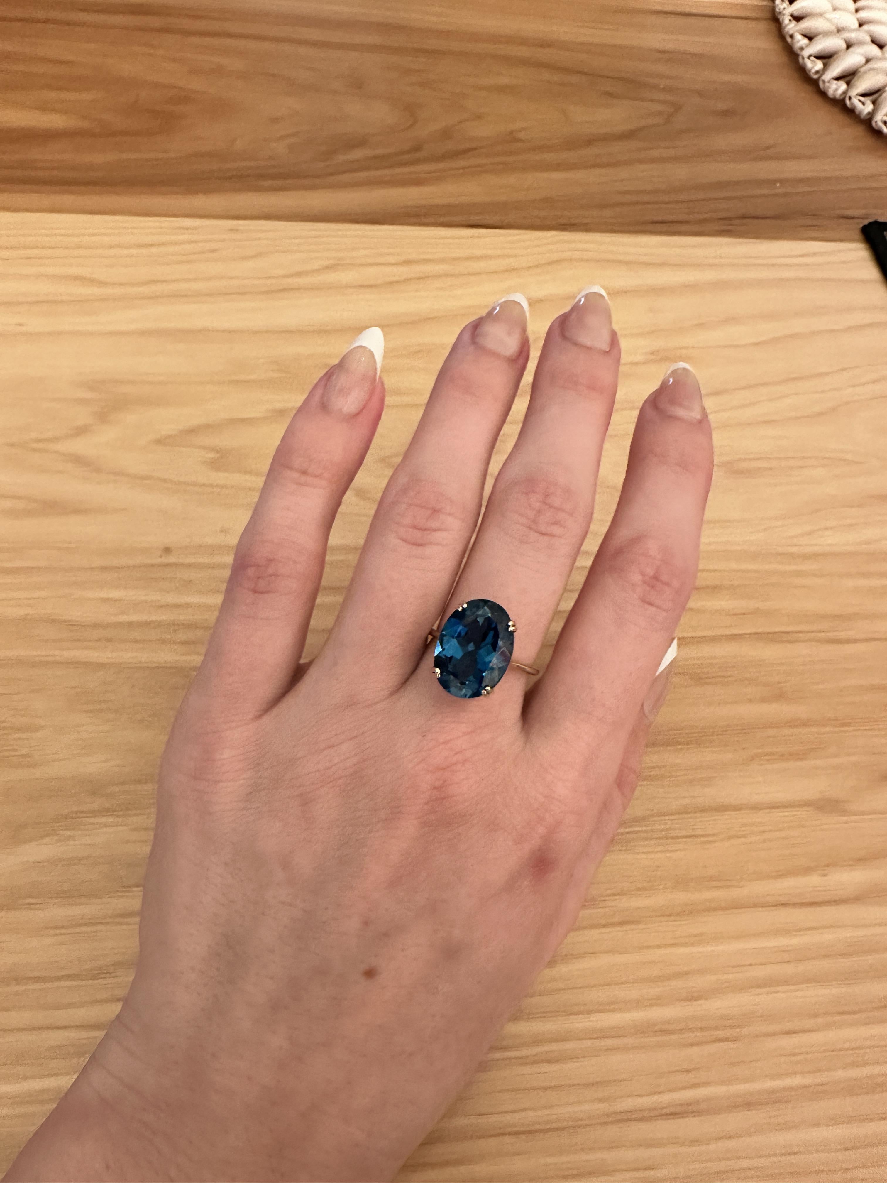Presenting our 10ct Solitaire London Blue Topaz Ring. This statement piece features a 14x11mm Oval Setting in 14k White, Rose, or Yellow Gold, making it perfect for any occasion. The London Blue Topaz, known as the December Birthstone, adds a touch