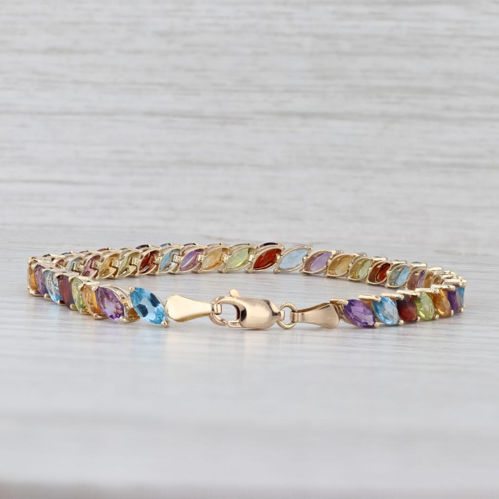 Gemstone Information: 10 Total Carats, Marquise Cut
- Natural Amethysts 1.85ctw, Topaz 2.55ctw, Garnets 2.10ctw, Peridots 1.89ctw, Citrines 1.61ctw

Metal: 14k Yellow Gold
Weight: 7.2 Grams 
Stamps: 14k
Chain Style: Tennis
Closure: Lobster