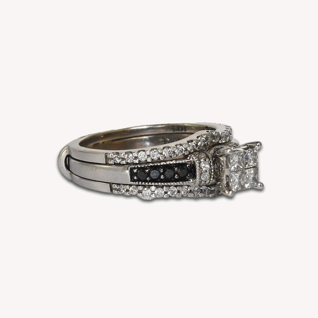 Ladies diamond ring set in 10k and 14k white gold. 
Stamped 10k on the central ring and 14k on the guard ring. 
Weighs 5.6 grams. 
There are four princess cut diamonds at the top, .28 total carats, h color, si clarity. 
On the sides are round