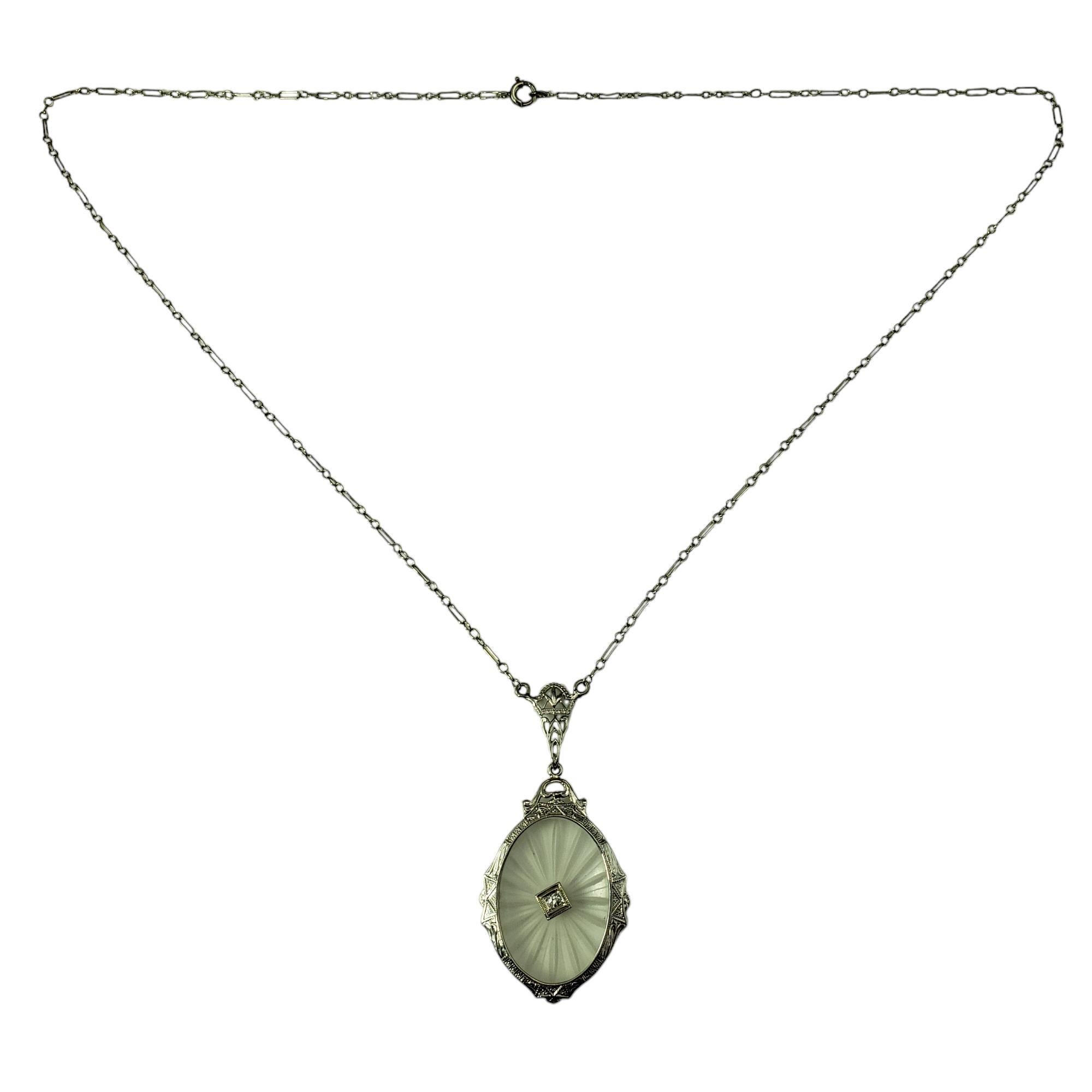 14 Karat White Gold Filigree Camphor Glass Pendant Necklace

This enchanting camphor glass pendant is framed in delicately etched 14K white gold filigree, creating a luminous effect. Accented with one round single cut diamond at its center. Suspends