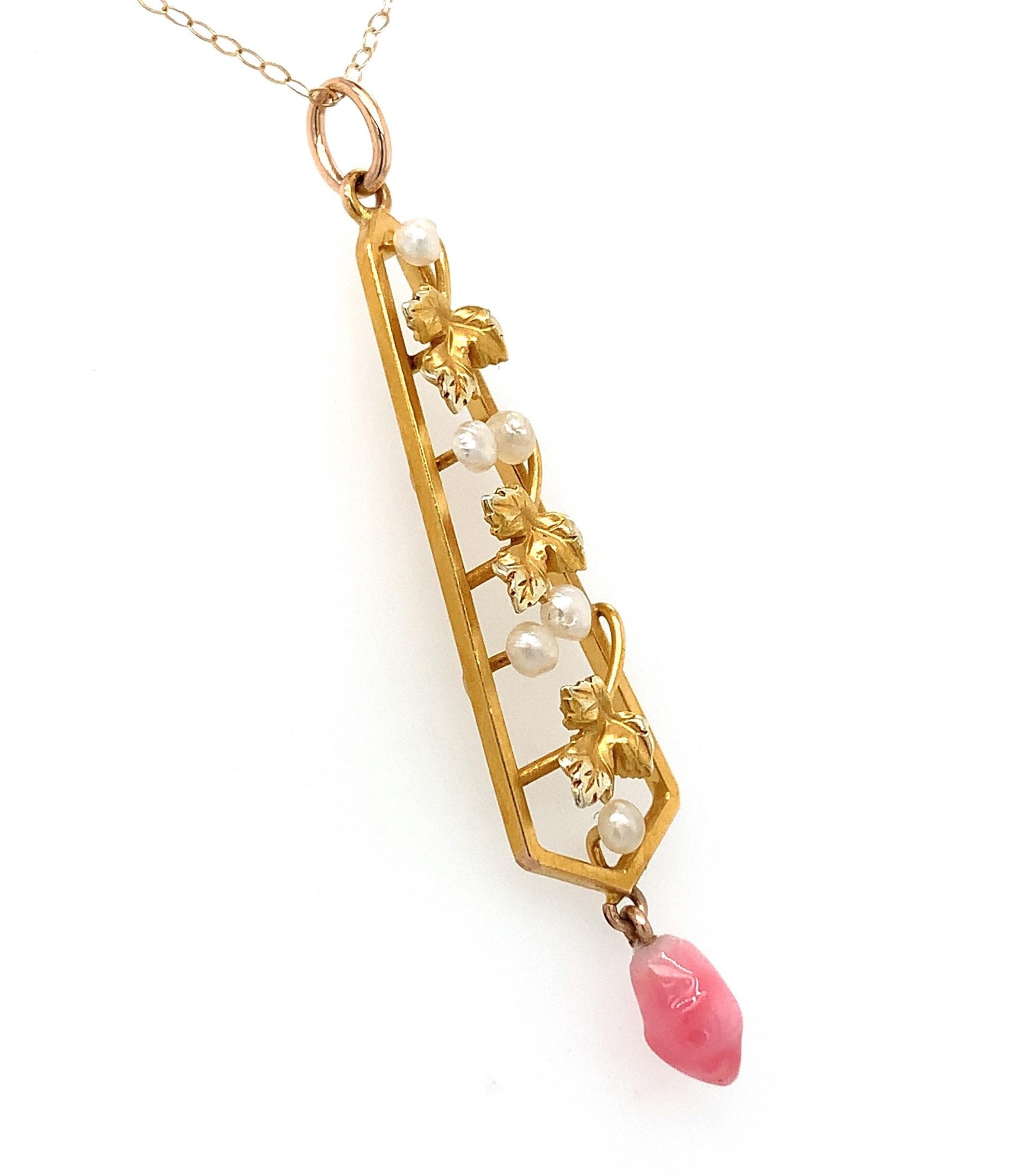  10K yellow gold Art Nouveau lavalier pendant featuring a conch pearl drop. The pink conch pearl weighs .74ct and measures 7.3mm x 3.8mm. It has bright bubble gum pink color and shows flame structure. The pendant measures 1 7/8