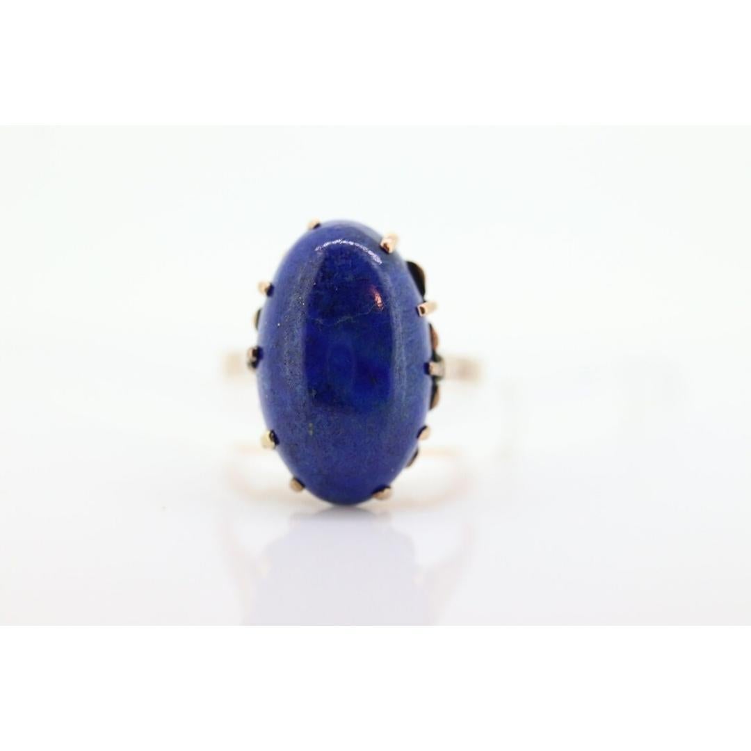 Vintage from the 1970s
Size: 7 1/4 US
Materials: Gold
Gemstone: Diamond
Gem color: Blue

Band Color: Gold

10k Yellow gold with Prong set Lapis Lazuli Cabochon Egg into a cathedral.

Condition: Shows signs of wear from age. Unmarked. Tests as