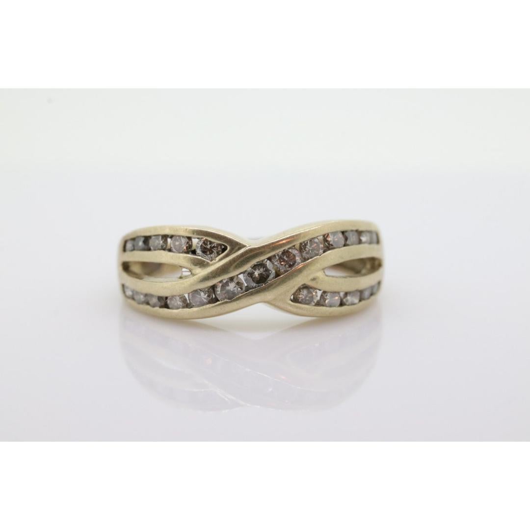 Vintage
Materials: Gold
Gemstone: Diamond
Gem color: Colorless
Band color: Yellow
Style: Minimalist
Wonderful 10k Cross Eternity Band with channel set diamonds.

Condition: 10k Yellow gold.

1.8mm to 2.2mm diamonds
2.9grams
7mm wide
size 5.5