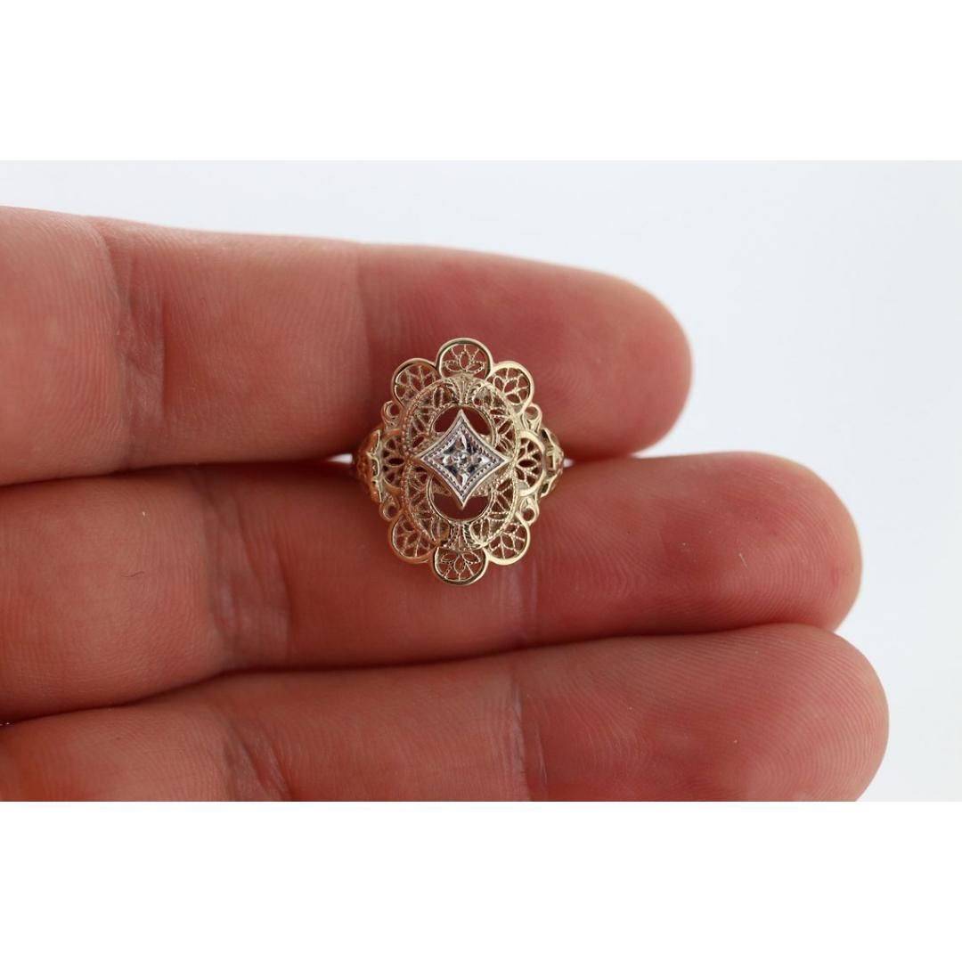 Vintage from the 1950s
Size: 5 3/4 US
Materials: Gold
Gemstone: Diamond
Gem color: Colorless
Band color: Gold

Style: Art deco

Very beautiful Art Deco diamond ring. Filigree open design shield with a center diamond set in a star