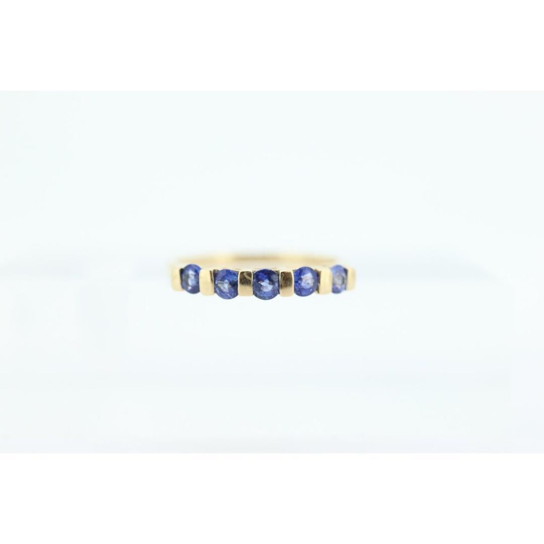 Vintage from the 1980s
Size: 5 US
Materials: Gold
Gemstone: Sapphire
Gem color: Blue
Band Color: Yellow

Style: Minimalist

Blue Sapphire Eternity Anniversary Band.

Channel set round cut sapphires.

Details:
Sapphires 2.8mm width
1.2grams total