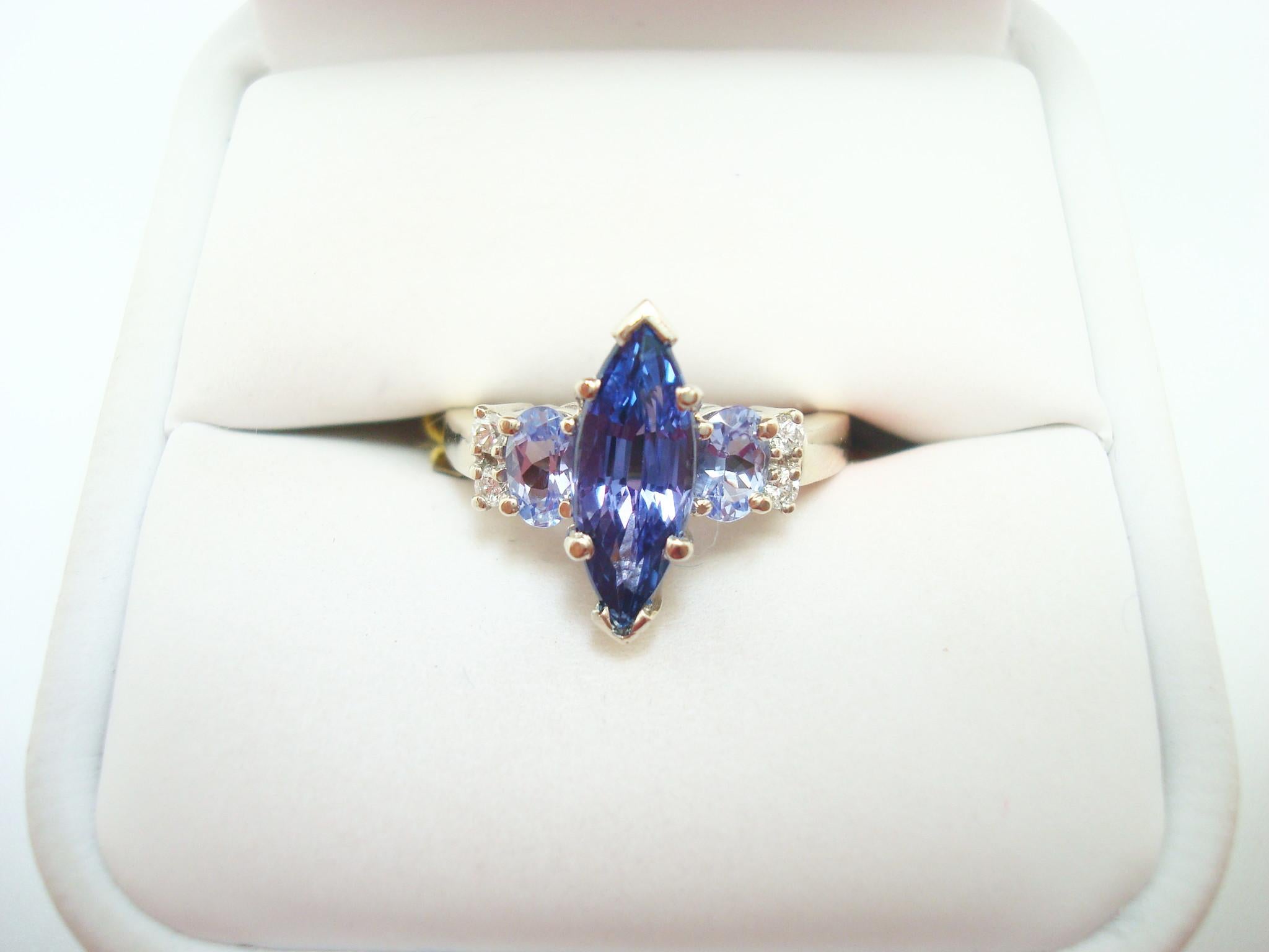 10K GOLD MARQUISE 1.68CT GENUINE NATURAL TANZANITE RING WITH DIAMONDS (#2643)

Captivating 10K white gold tanzanite and diamond ring featuring a ravishing marquise center tanzanite that is approximately 1.68 carats and it measures 14x5mm.  Set on