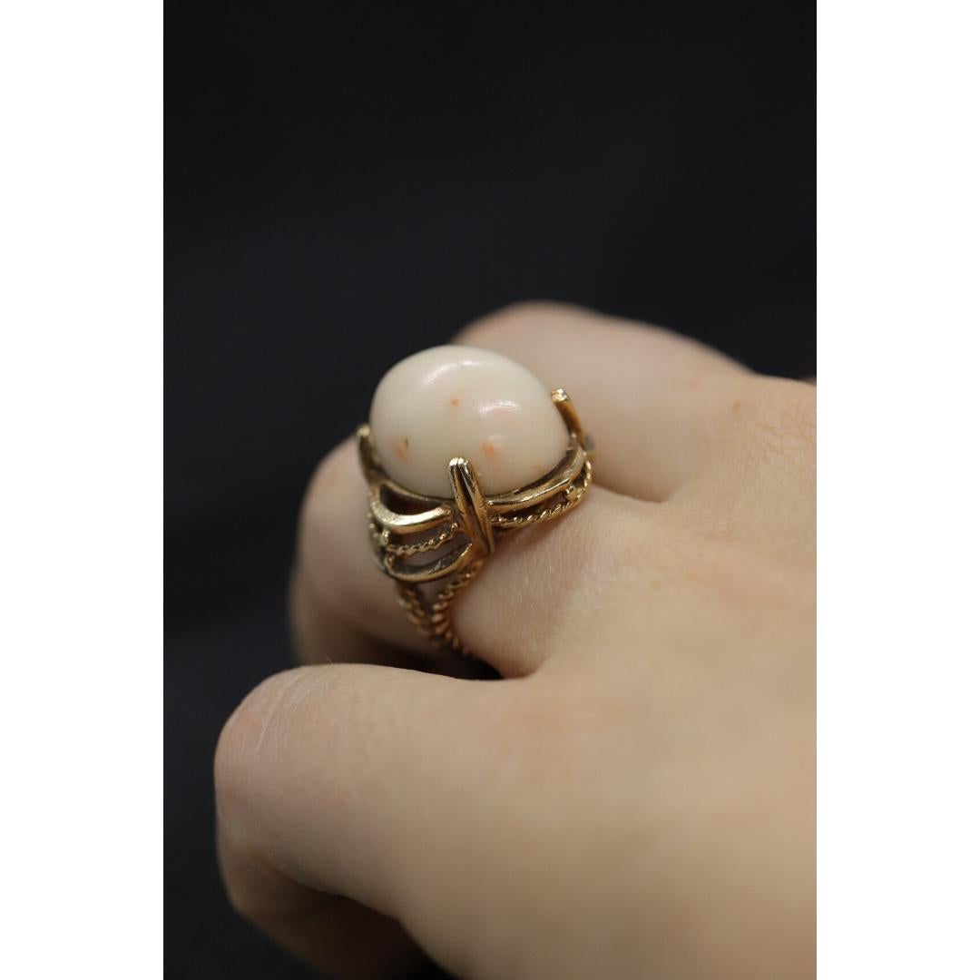 Vintage from the 1970s
Size: 4 1/2 US
Materials: Gold
Gemstone: Coral

Band Color: Gold

Amazing Statement ring. 14k yellow gold set with a Pink or Angel Skin CORAL. The Coral is very large. It is overall a stunning piece.

Condition: Shows some