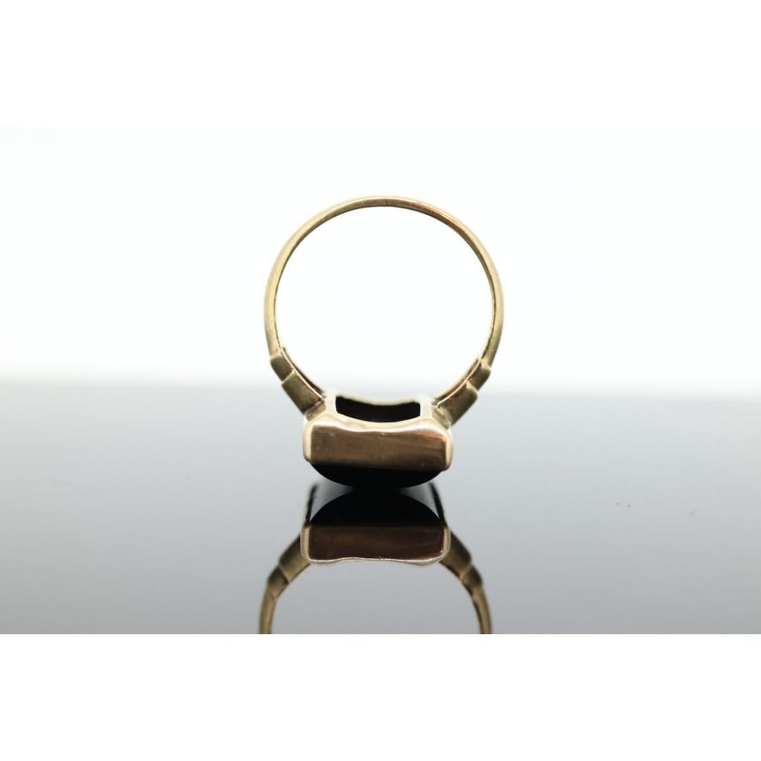 Vintage from the 1950s
Size: 6 US
Materials: Gold
Gemstone: Onyx
Gem color: Black

Band color: Gold

About this item

This is a super unique ring. Onyx cabochon rectangle in bezel setting. Made by PSCO

Condition: Shows minimal signs of wear. Onyx