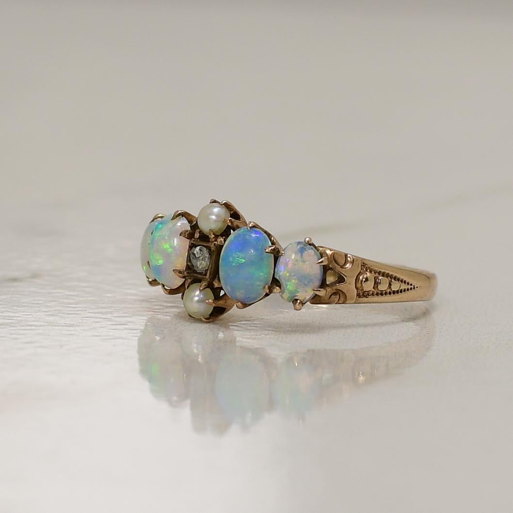 Elevate your jewelry collection with the enchanting beauty of this vintage 10K Opal, Pearl, and Diamond Gemstone Ring. Its centerpiece is a mesmerizing opal, radiating a kaleidoscope of colors that dance with each movement. The opal is beautifully